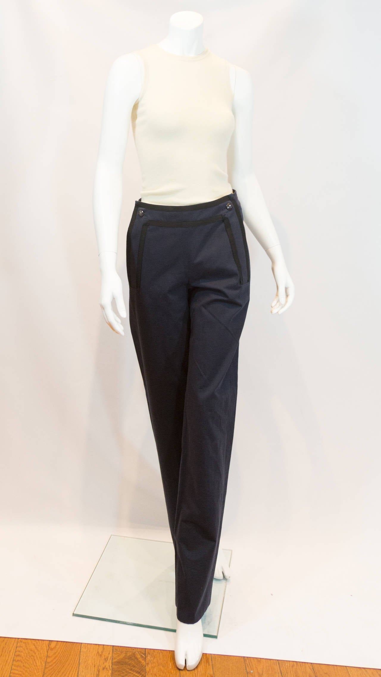 Chanel dark navy blue pants with black grosgrain detail and two buttons with the double C logo. From the Spring 2014 Collection with original tags.