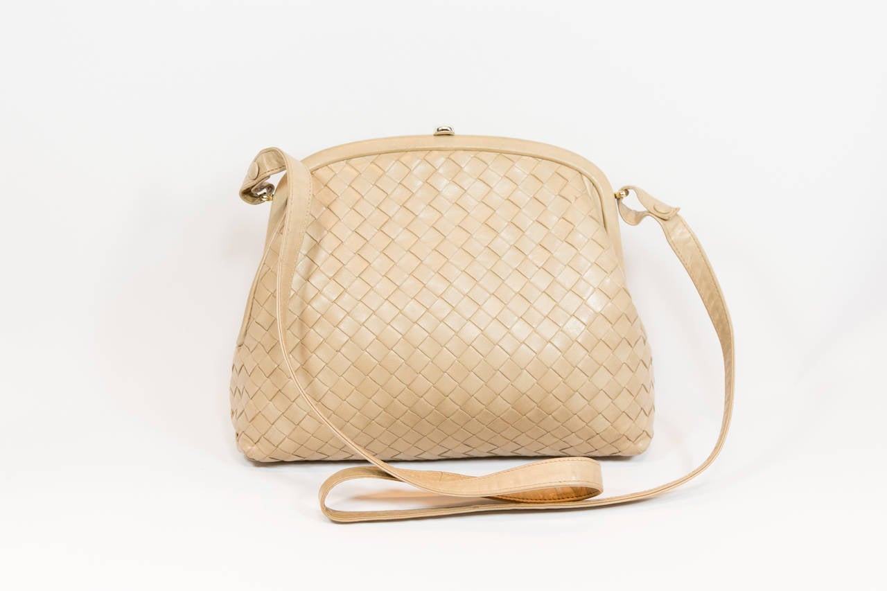 Bottega Veneta tan basket weave leather cross body bag with long strap.