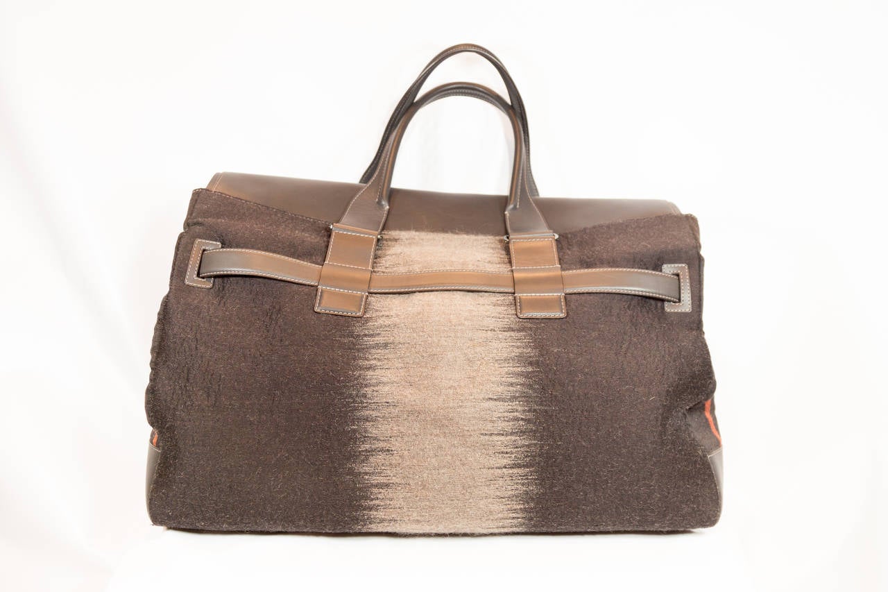 Salvatore Ferragamo brown leather overnight bag with multicolor fabric and brown leather handles. Brown leather strap and silver buckle fastener in the front.