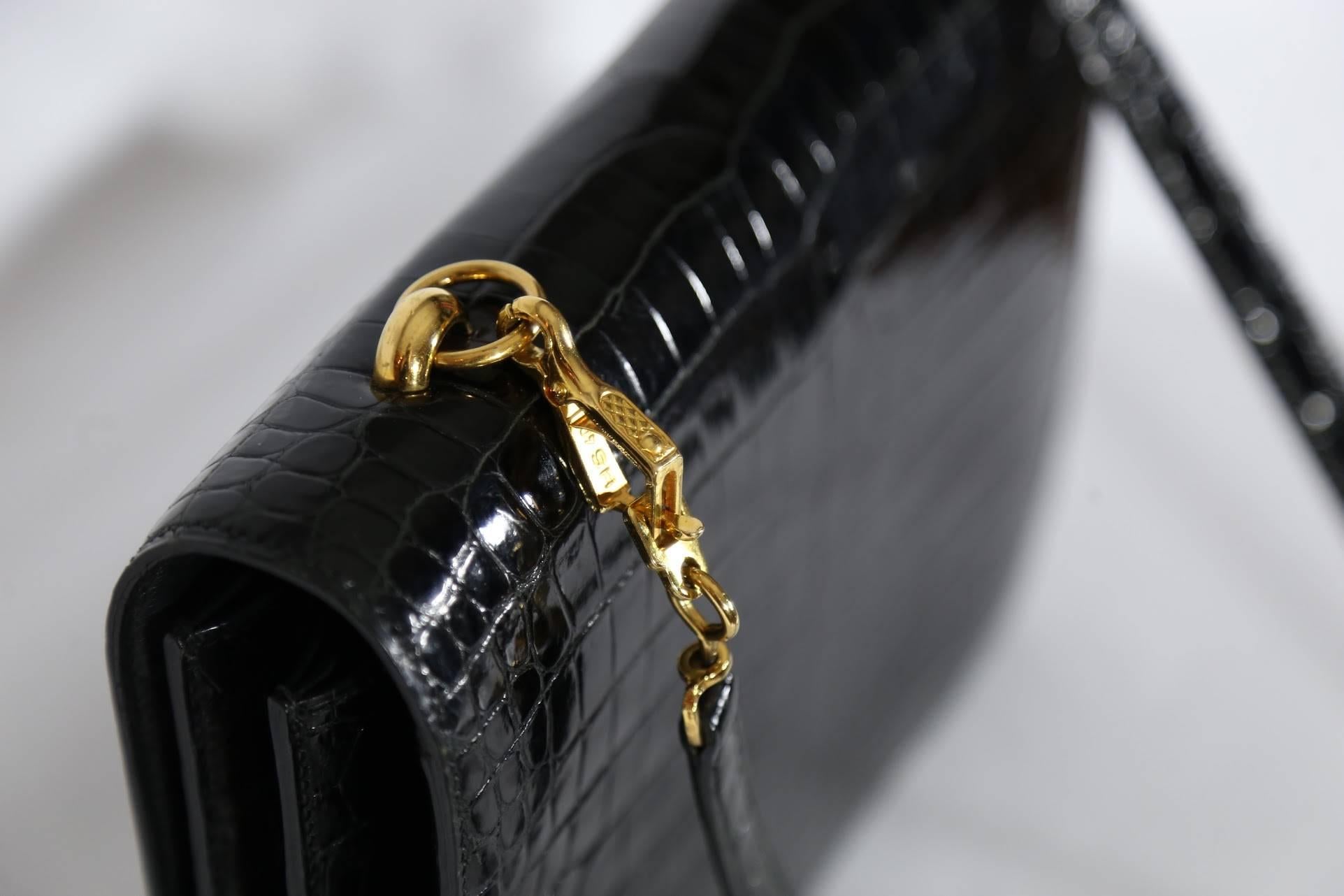 Hermes black porosus crocodile Sandrine bag with gold chain. 