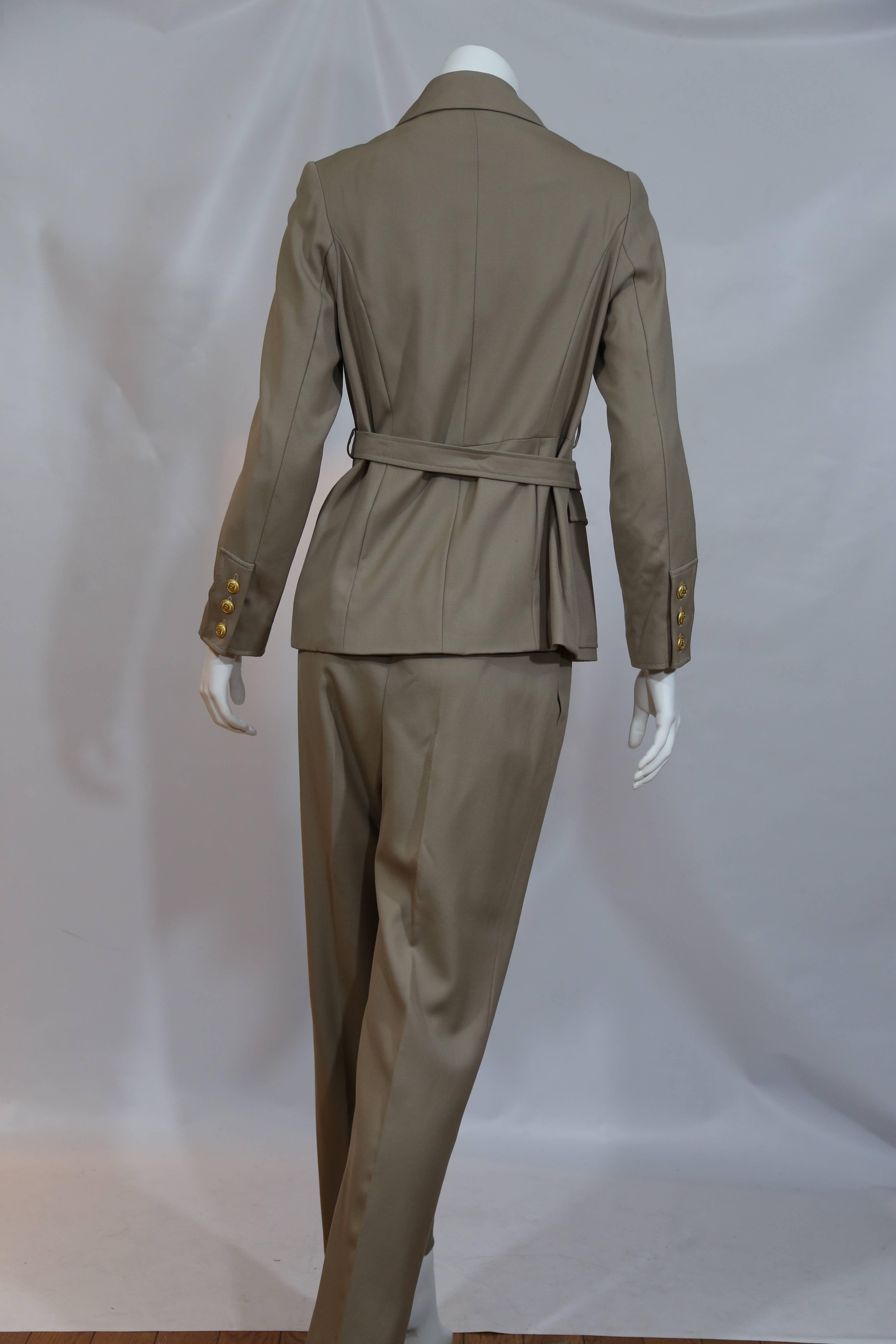 Chanel taupe pantsuit with signature gold buttons. 