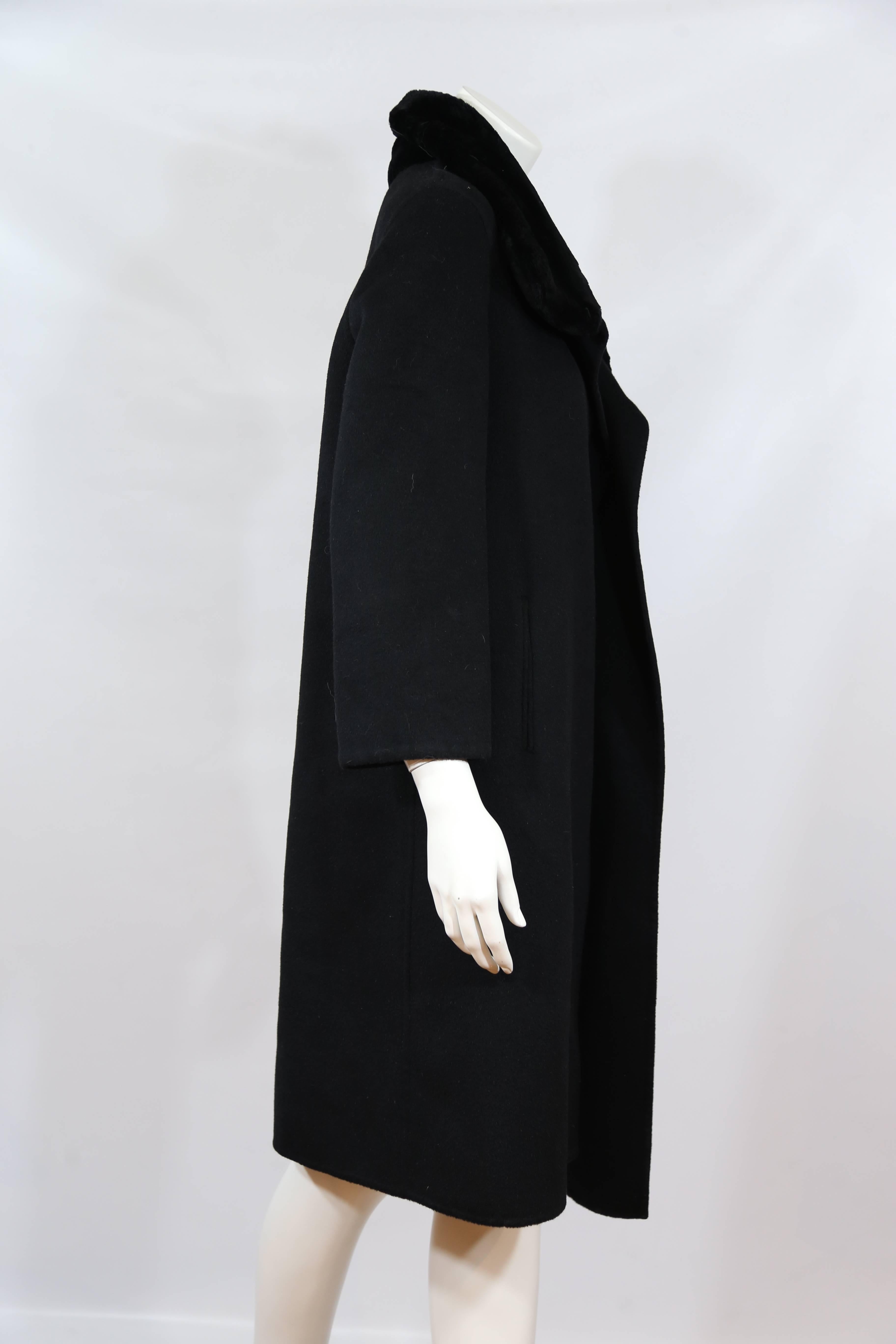 Michael Kors black wool coat with collar and hidden button closure.