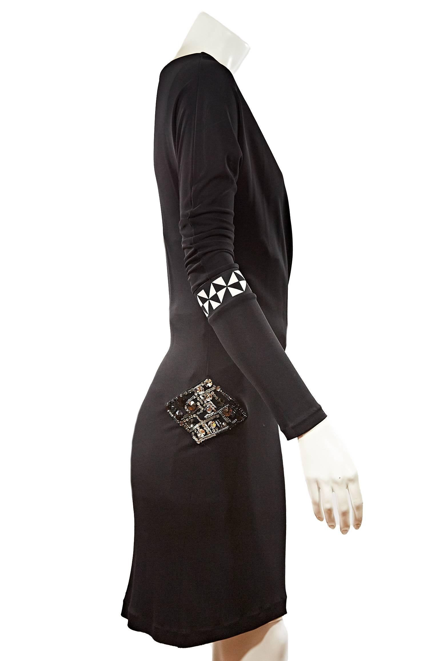 Emilio Pucci Black Viscose Dress w/ Rhinestone Applique. Long sleeve w/ draped necklace. White & black triangle design on sleeves. Above the knee.