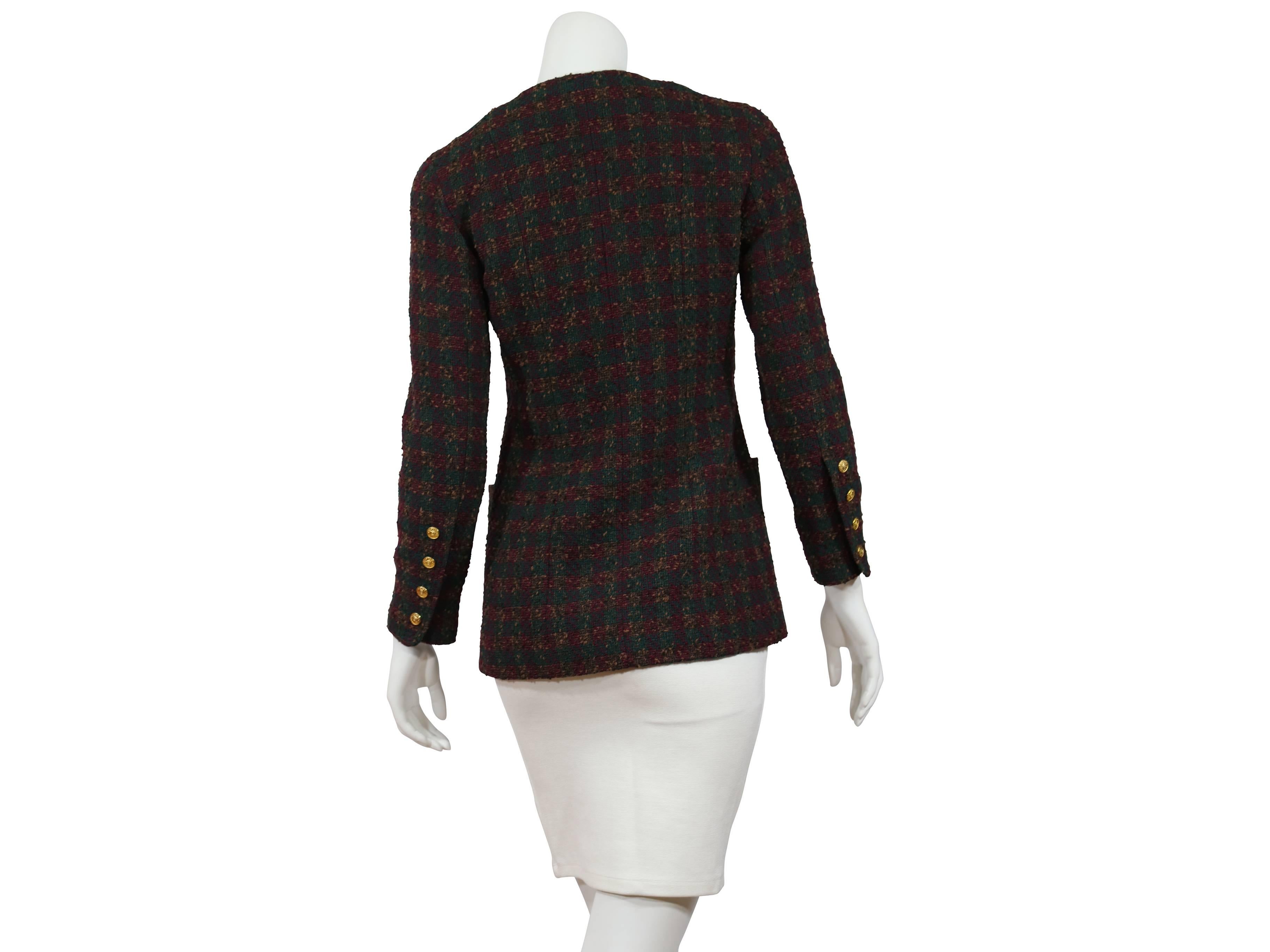 Green and eggplant checkered tweed jacket by Chanel.  Crewneck. Button-front closure.  Four patch pockets.  Long sleeves with four-button detail at cuffs.