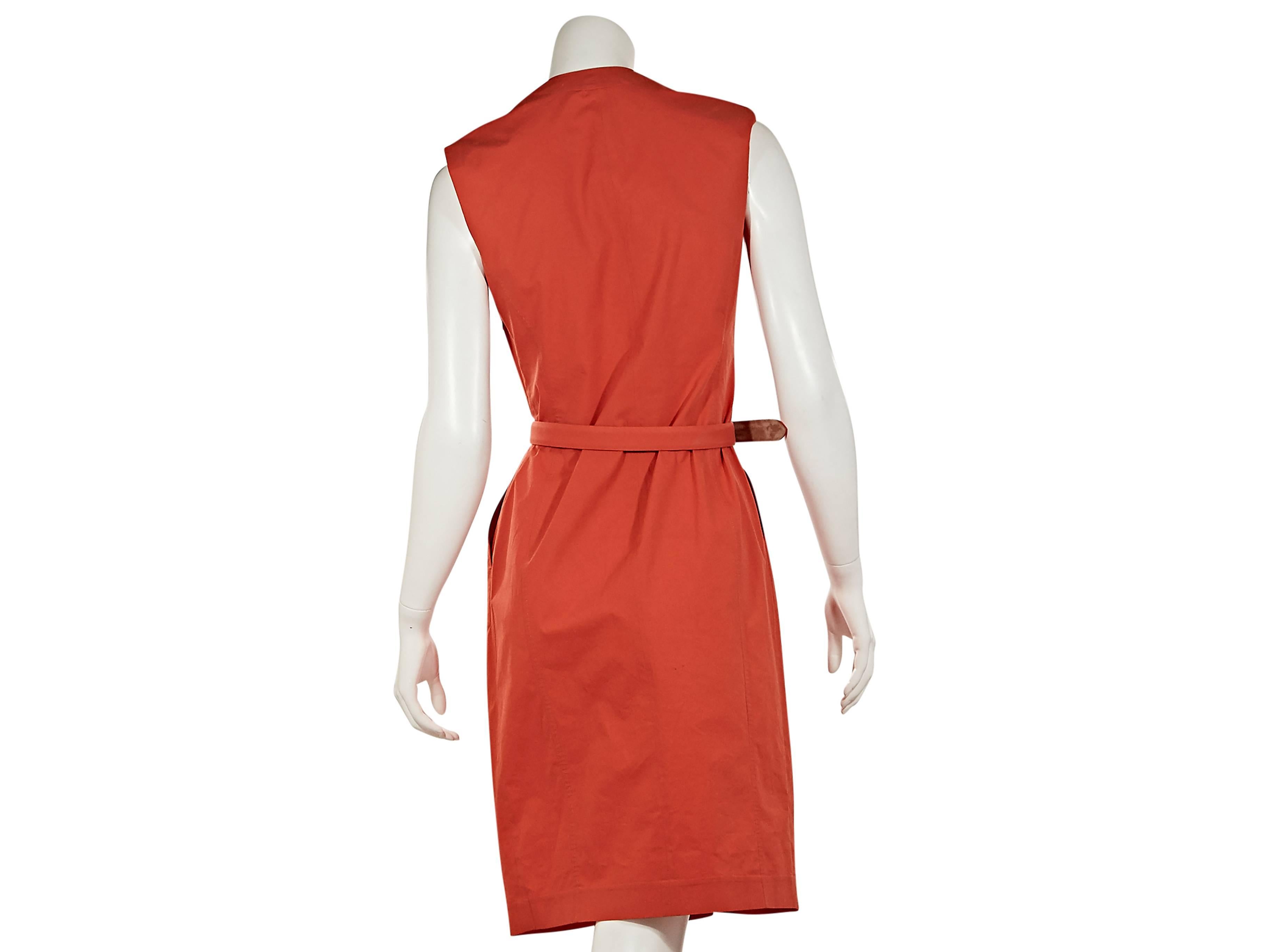  Orange cotton belted dress by Salvatore Ferragamo.  Diagonal pleats accent front.  V-neck.  Sleeveless.  Adjustable belted waist.  Side slash pockets.