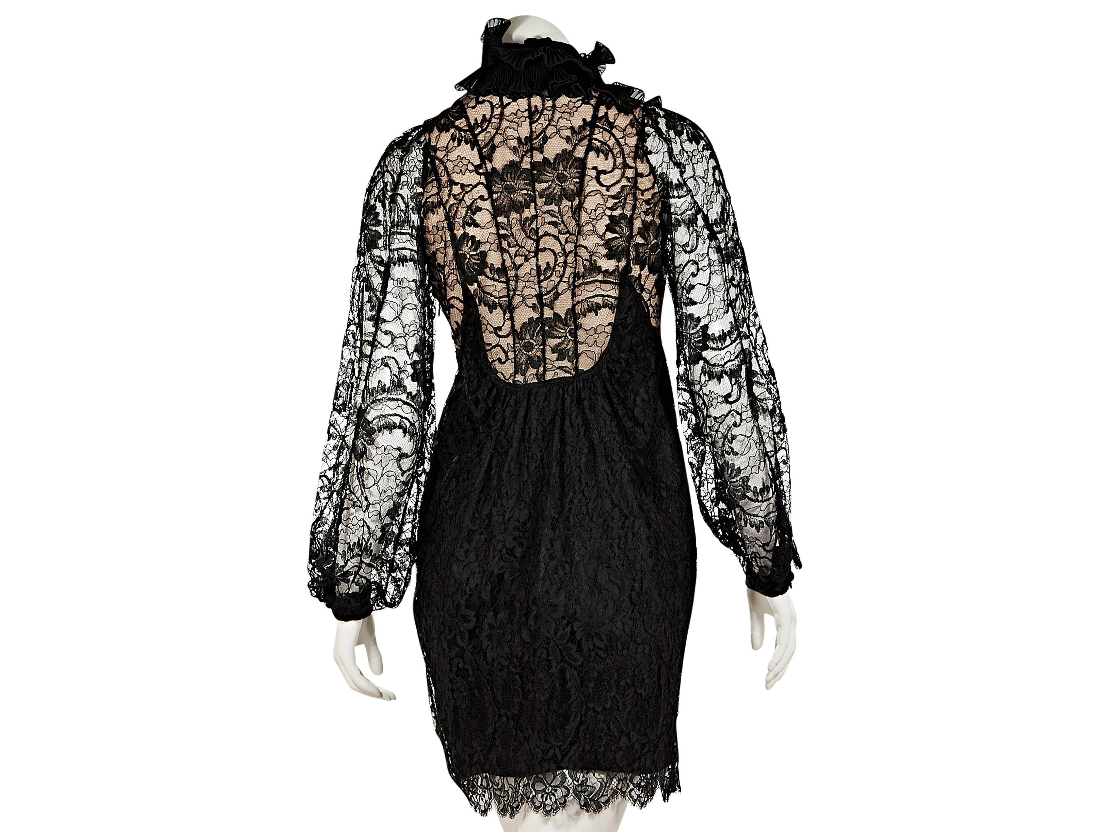 Black lace dress by Givenchy.  Stand collar.  Sheer lace long sleeves.  Ruffled bodice.  Concealed button-front placket.  Peek-a-boo lining.  Scalloped hem. 