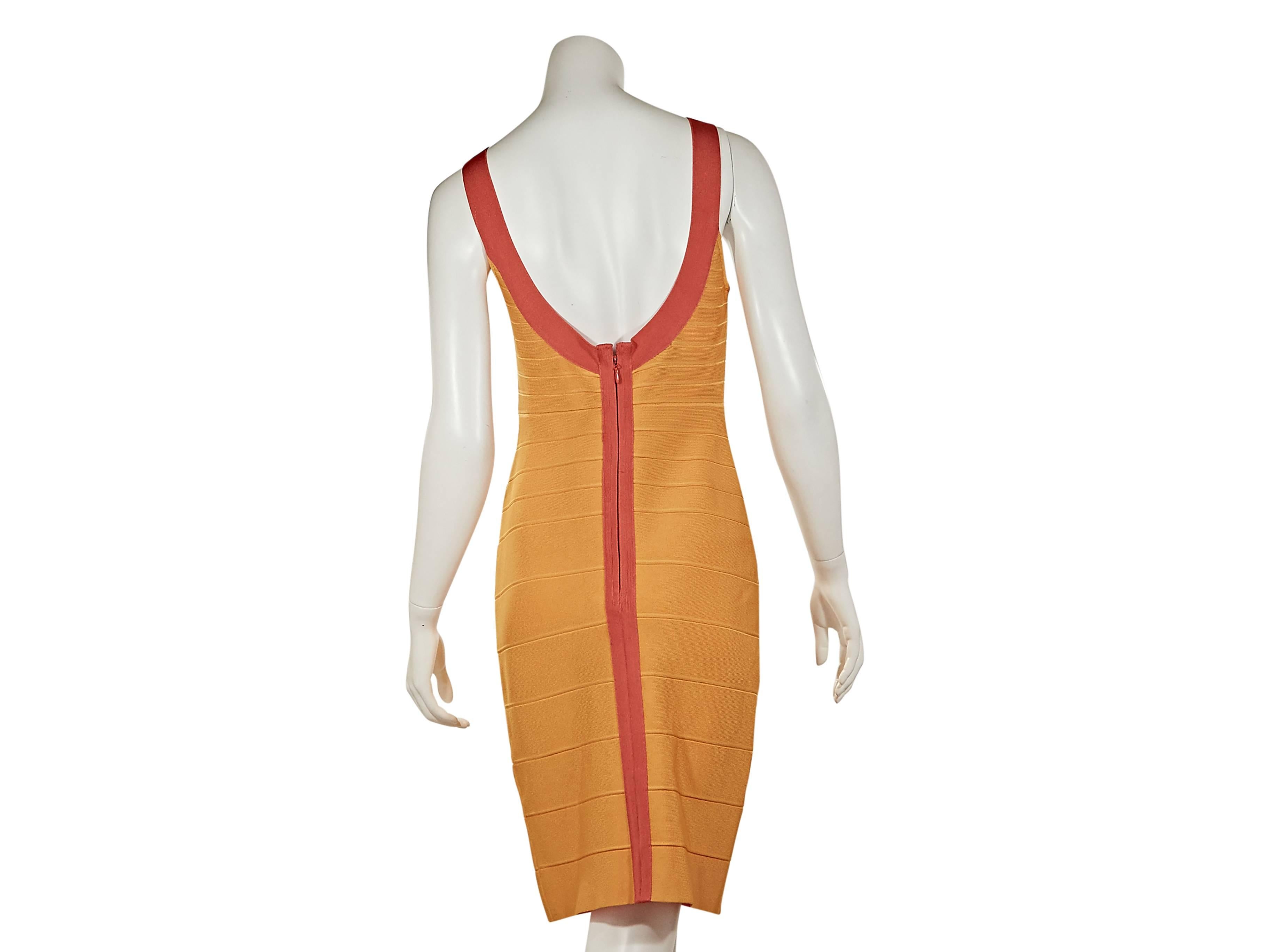 Yellow and orange bandage dress by Herve Leger.  Deep scoopneck and back.  Sleeveless.  Concealed back zip closure.  
