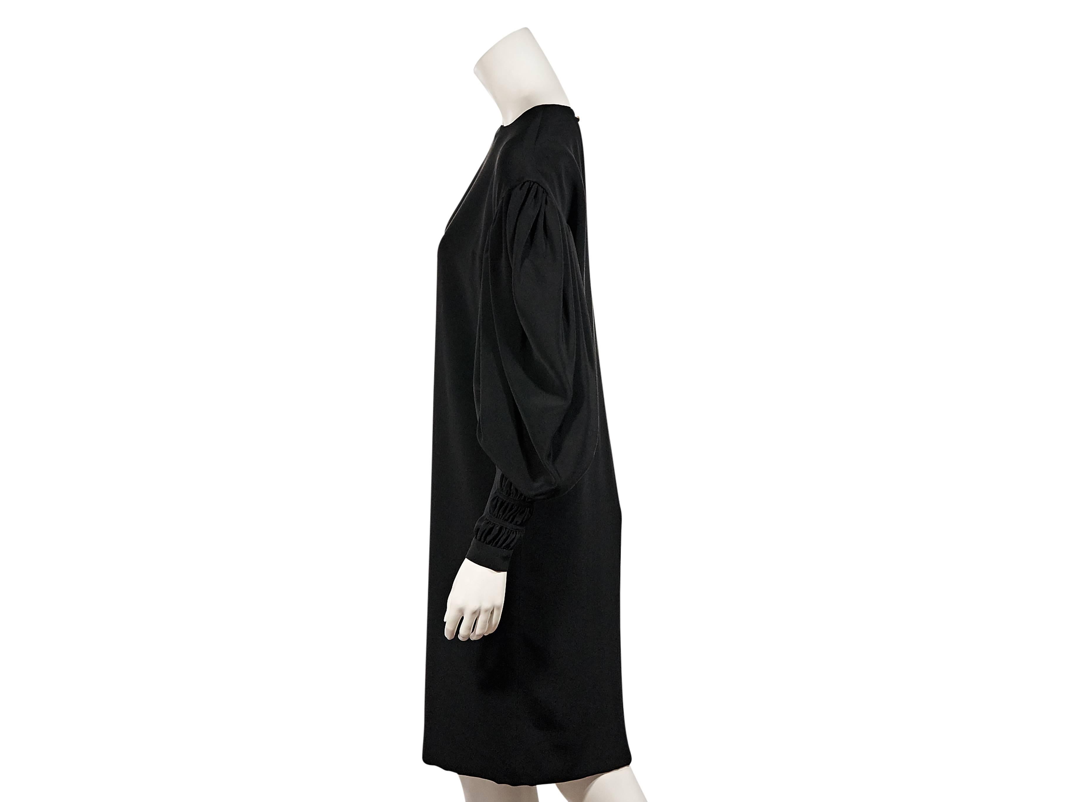 Product details:  Vintage black long-sleeve dress by Chanel.  Wide crewneck.  Long draped sleeves.  Ruched cuffs.  Back button closure.  Keyhole cutout.  Label size FR 38.
Condition: Excellent. 
Est. Retail $ 2,488.00