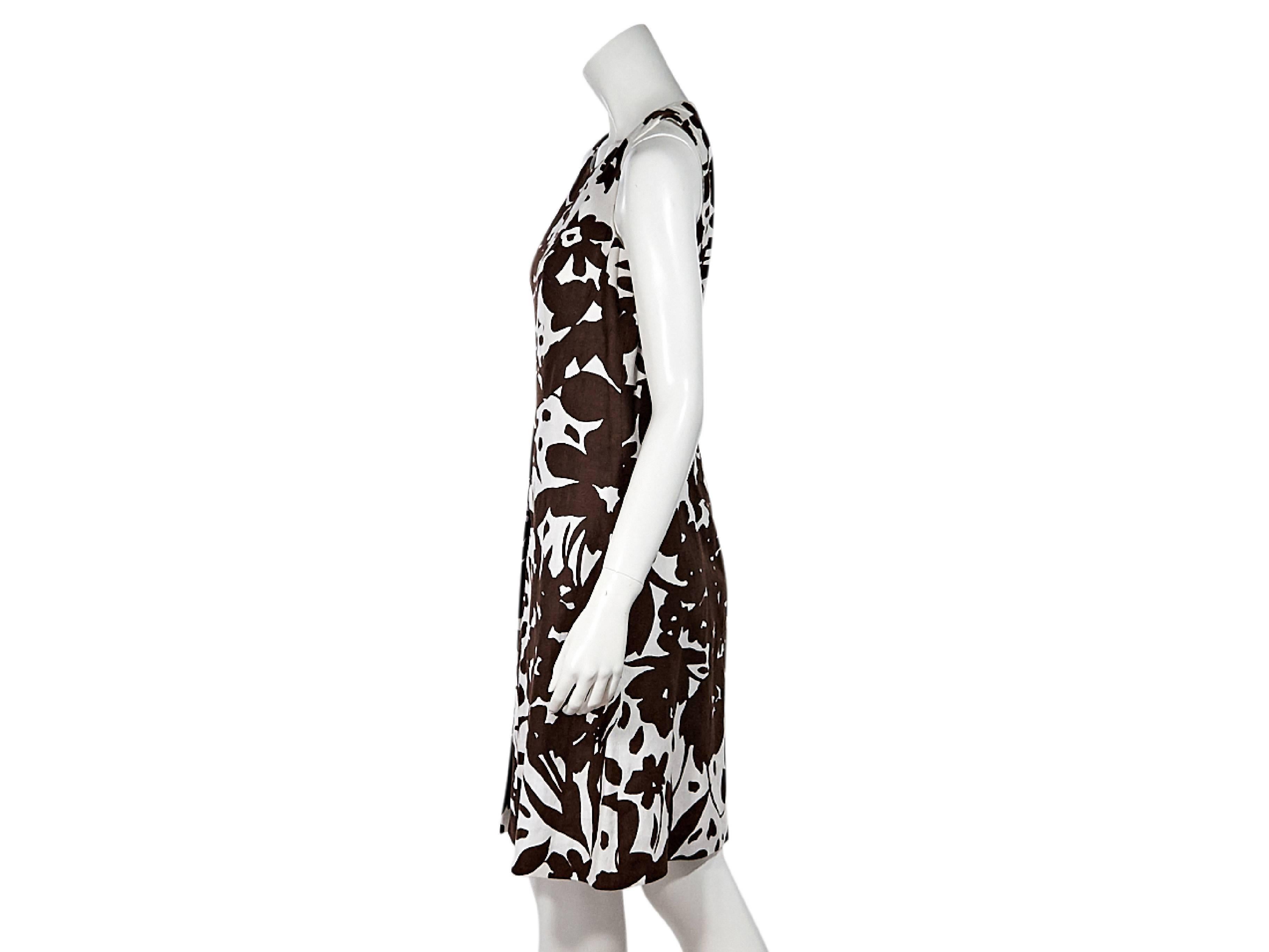 Product details:  Brown and white floral-printed sheath dress by Michael Kors.  Sccopneck.  Sleeveless.  Front box pleat.  Concealed back zip closure.  
Condition: Pre-owned. New with tags.