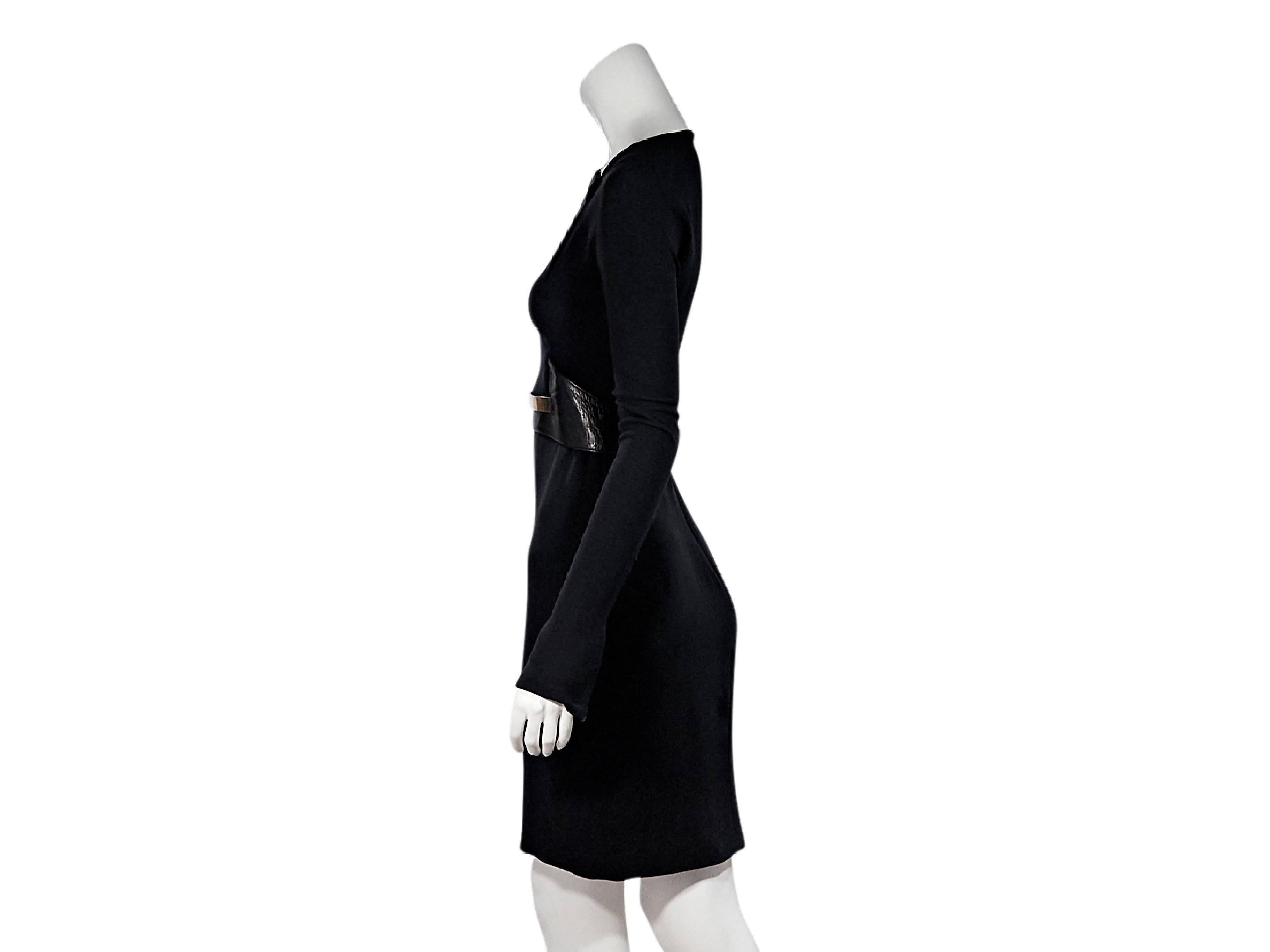 Product details:  Black form-fitting belted dress by Gucci.  Features cutout accents.  Squareneck.  Long sleeves.  Zip cuffs.  Metallic leather belted waist.  Concealed back zip closure.  
Condition: Pre-owned. Very good.  
Est. Retail $ 978.00
