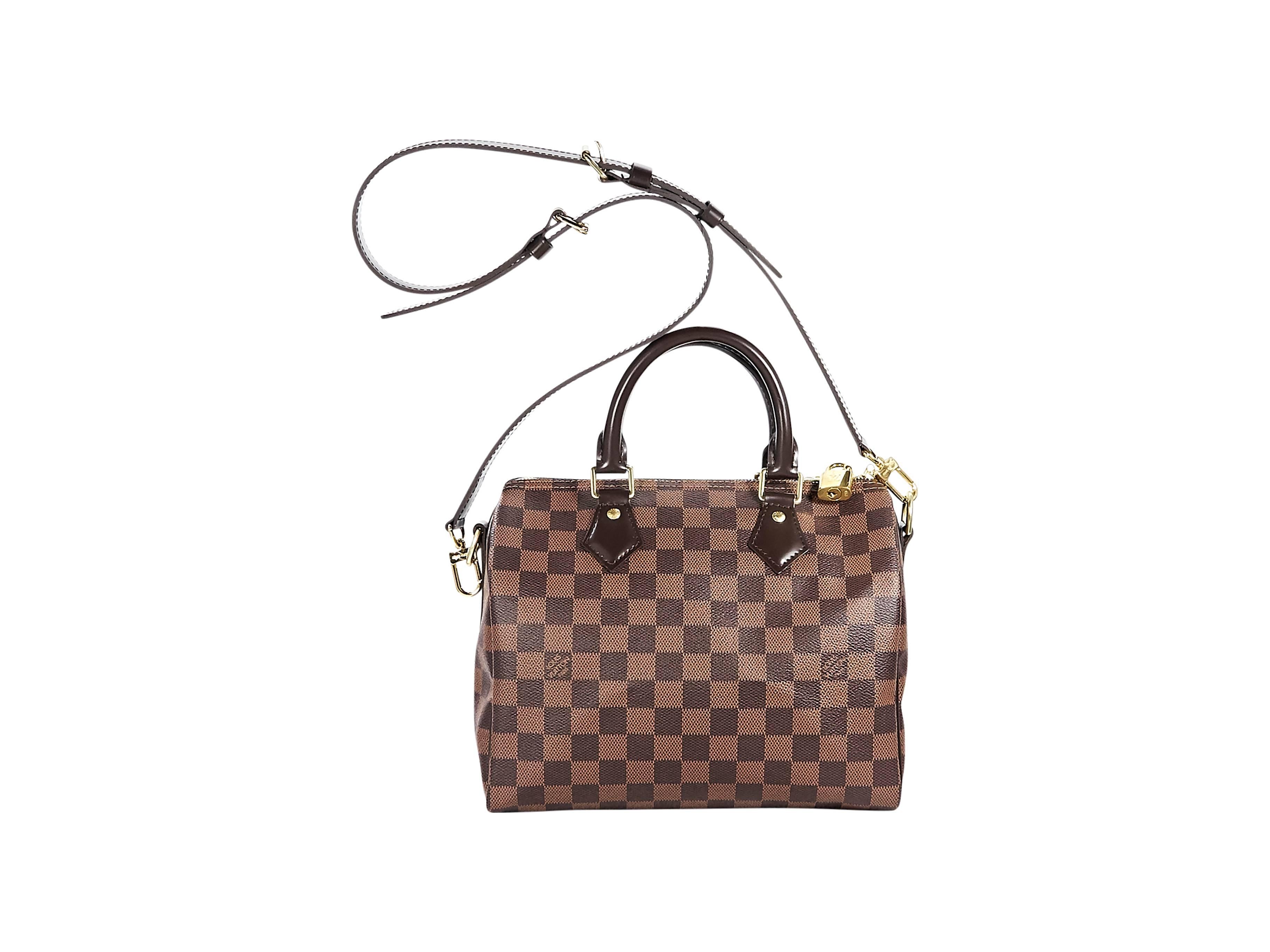 Product details:  Brown damier ebene Speedy Bandouliere 25 bag by Louis Vuitton.  Dual leather carry handles.  Detachable, adjustable leather crossbody strap.  Top zip closure with padlock.  Lined interior with inner zip pockets.  Goldtone hardware.