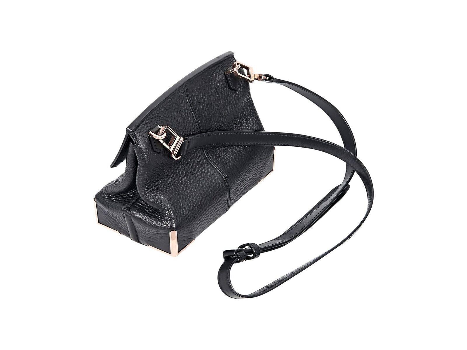 Product details:  Black leather Marion crossbody bag by Alexander Wang.  Detachable, adjustable crossbody strap.  Front flap with concealed closure.  Lined interior with inner zip pocket.  Flat bottom with protective metal corners.  Rose gold-tone