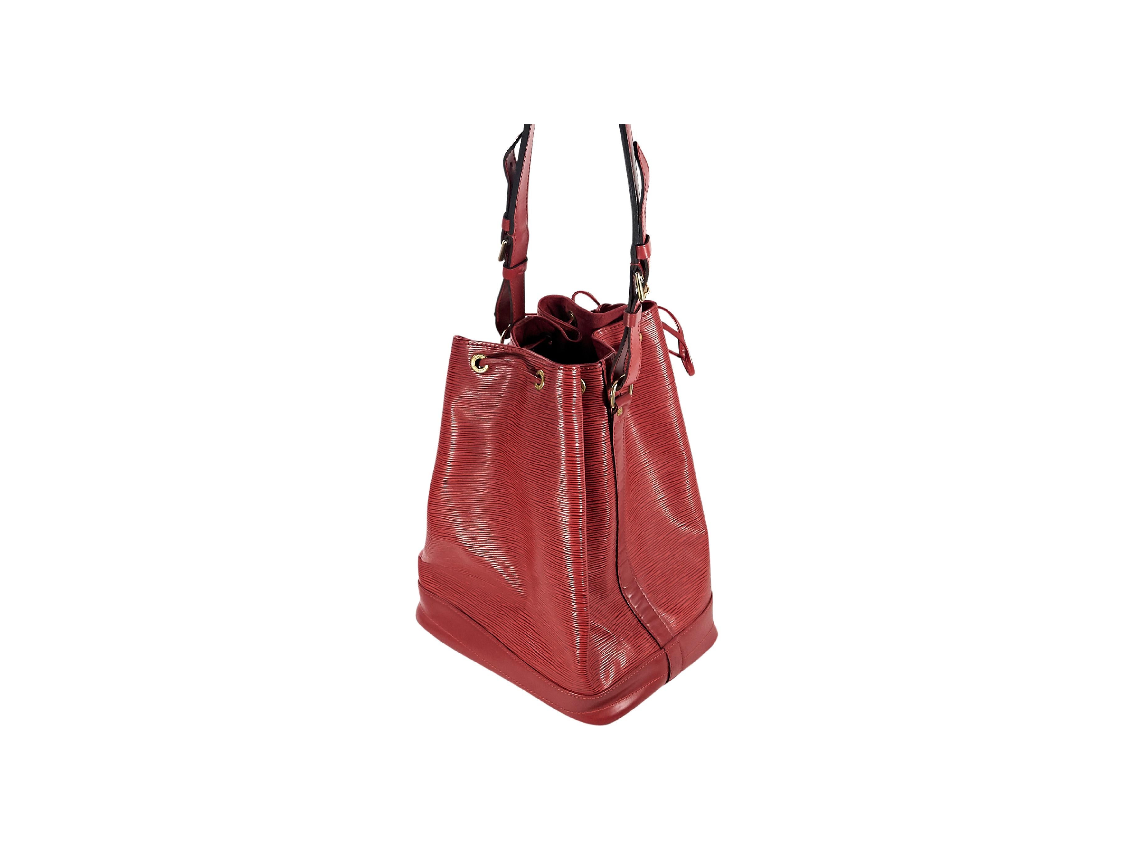 Product details:  Red epi leather Noe GM bucke tbag by Louis Vuitton.  Adjustable shoulder strap.  Drawstring top closure.  Lined interior.  Goldtone hardware.  14.5