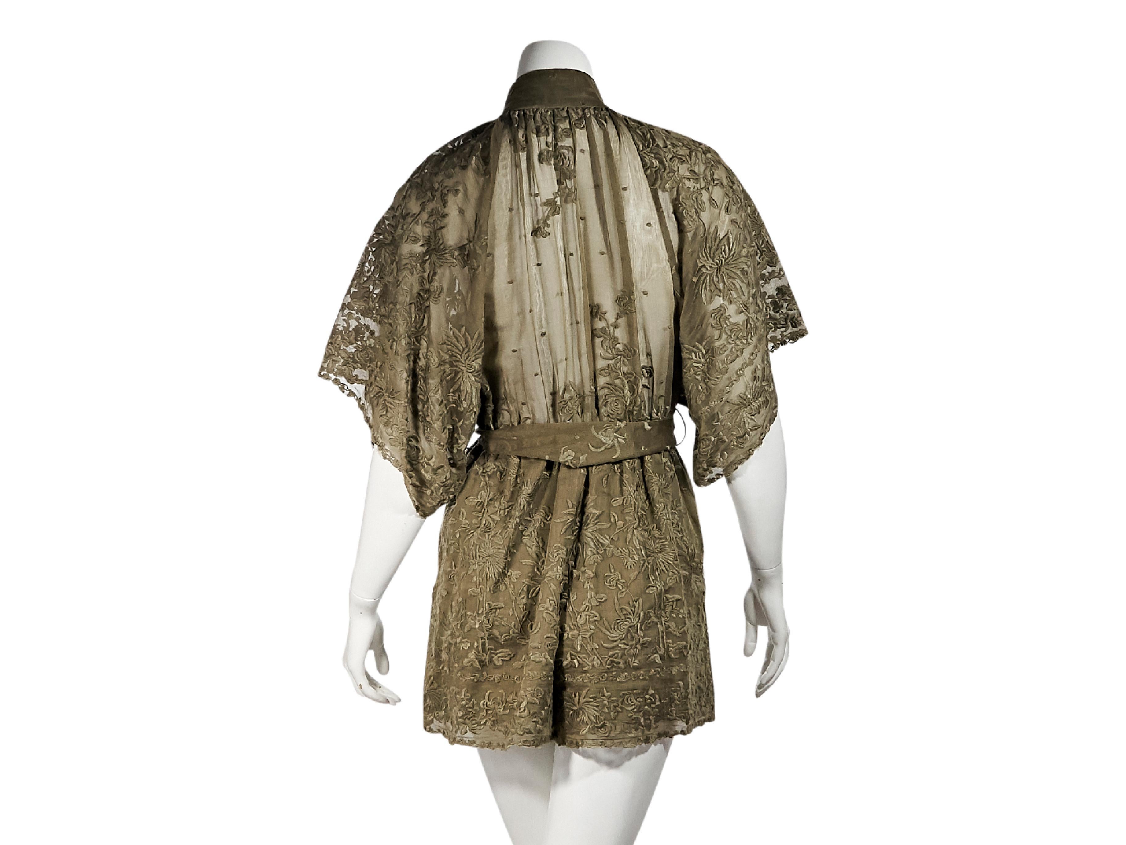 Product details:  Khaki floral embroidered cotton and silk blend romper by Zimmermann.  Stand collar.  Elbow-length dolman sleeves.  Button-front bodice.  Self-tie belted waist.  23