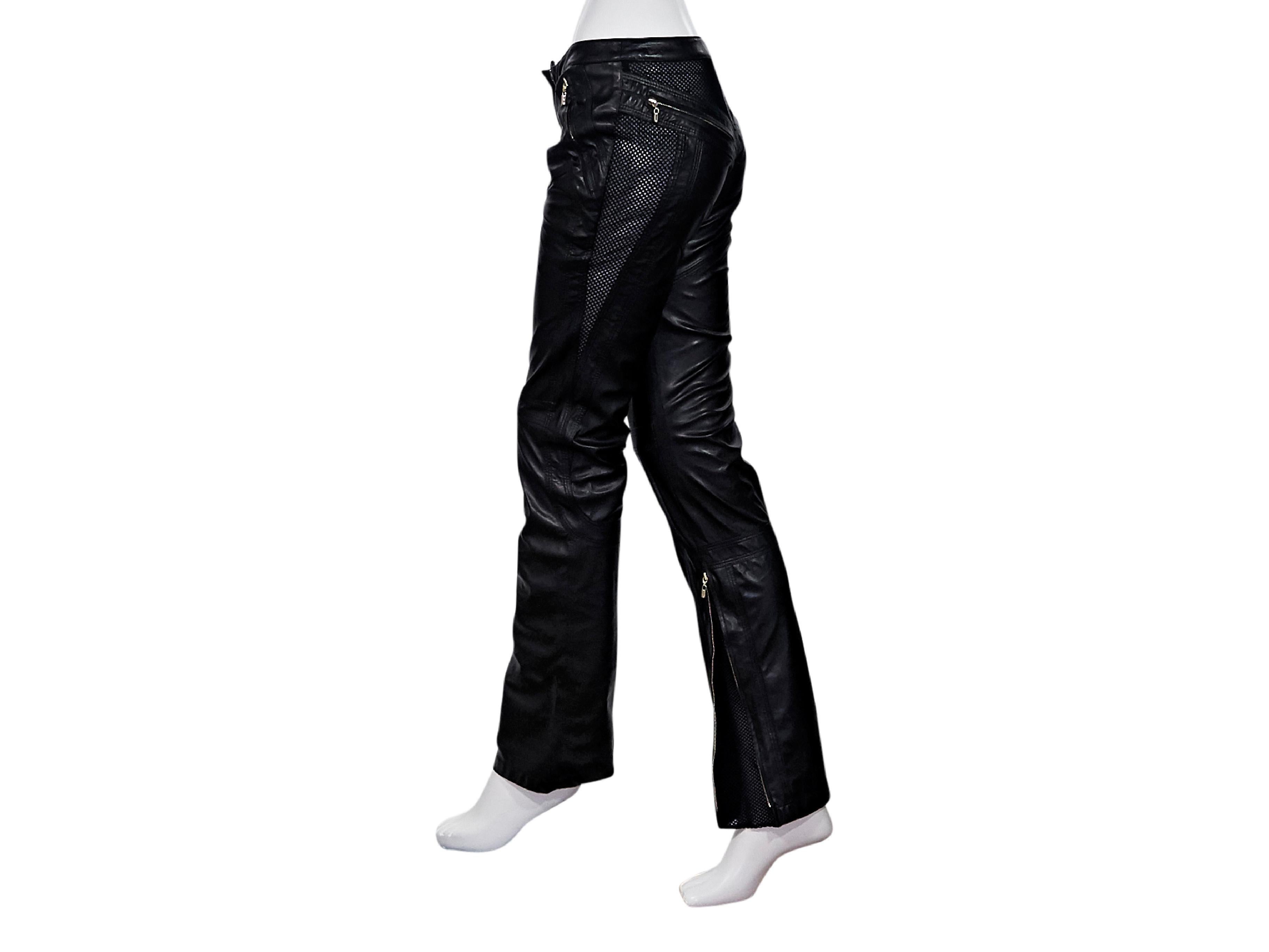 Product details:  Black leather pants by Gianni Versace Couture.  Accented with mesh panels.  Concealed hook closure with zip fly.  Waist and back zip pockets.  Inner hem with zipprer plackets.  Goldtone hardware.  28