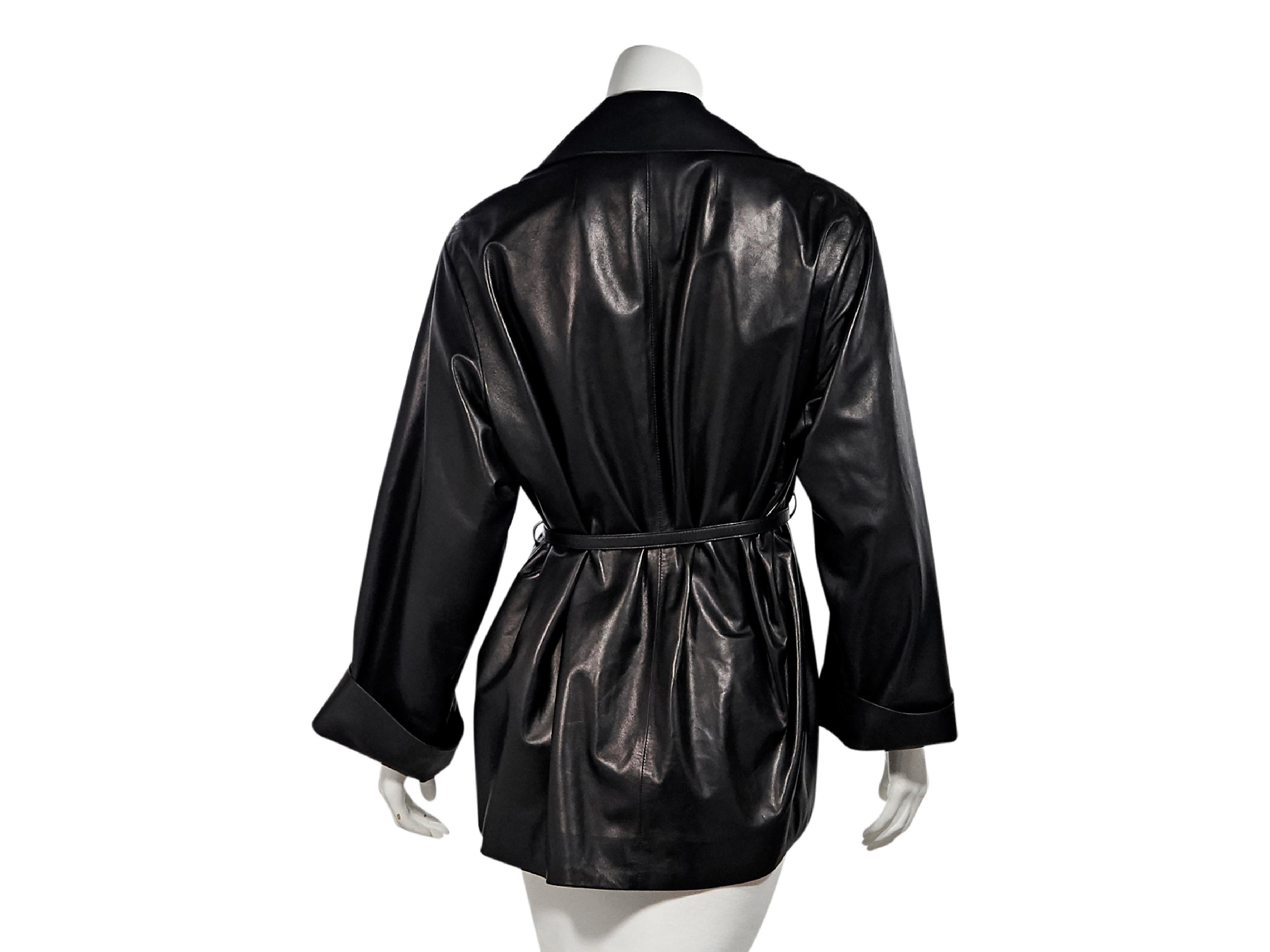 Product details:  Black lambskin leather jacket by The Row.  Peaked lapel.  Long sleeves.  Turn-back cuffs.  Self-tie belted waist.  40
