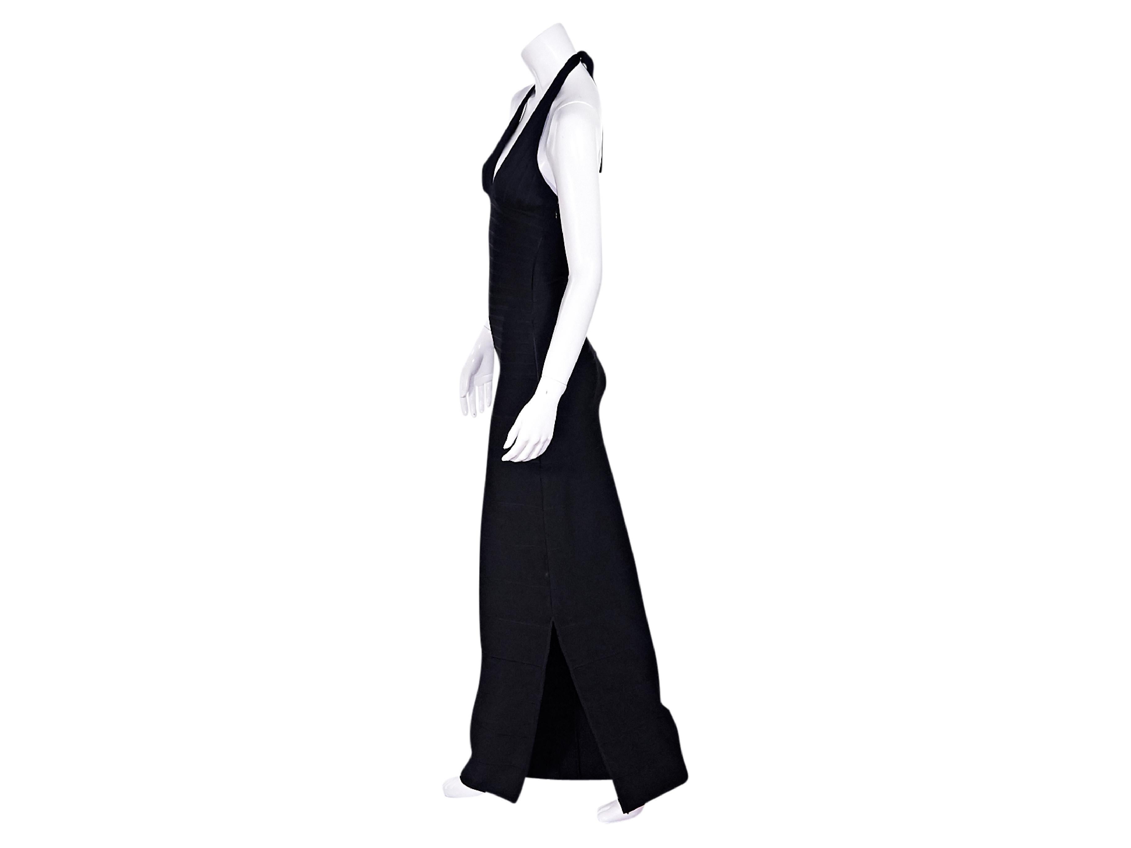 Product details:  Black stretch bandage gown by Herve Leger.  Self-tie halterneck.  Scoopneck.  Concealed side zip closure.  23