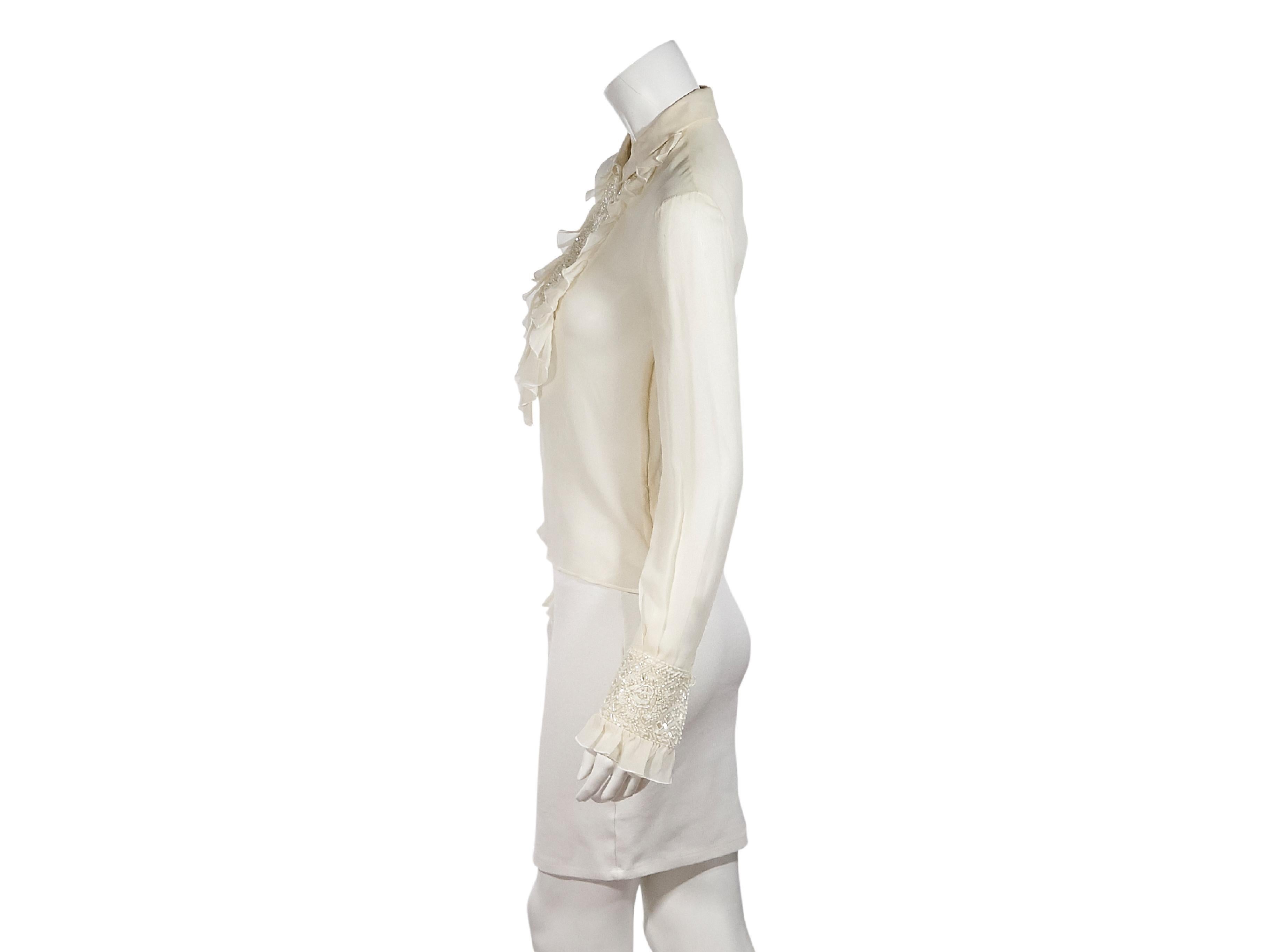 Product details:  Cream silk chiffon blouse by Valentino.  Beaded and ruffle bib.  Spread collar.  Long sleeves.  Beaded ruffle cuffs.  Half button-front placket.  Pullover style.  32