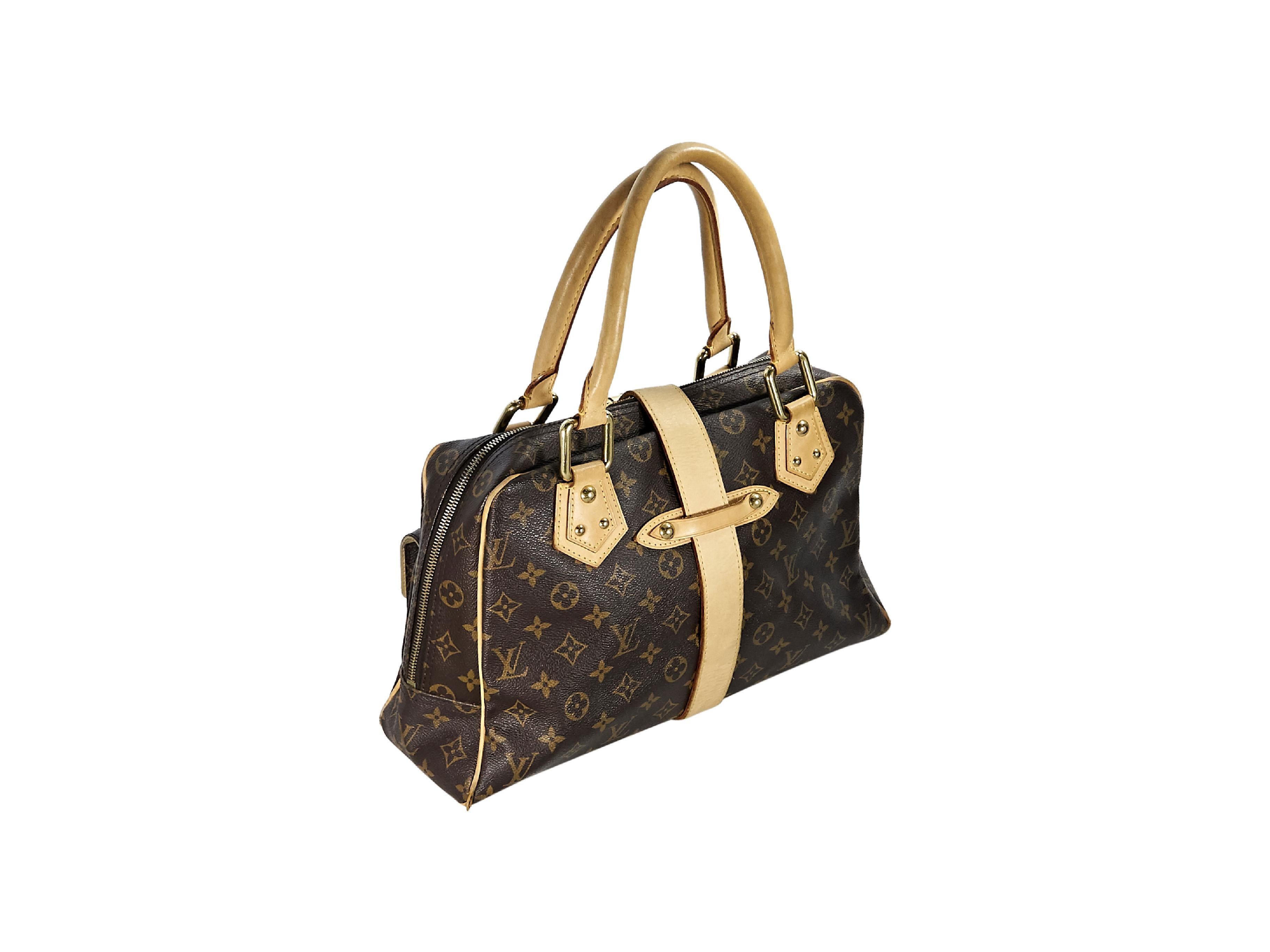 Product details:  Brown monogram coated canvas Manhattan GM bag by Louis Vuitton.  Trimmed with tan leather.  Dual carry handles.  Buckle strap over double top zip closure.  Lined interior with inner slide pocket.  Front push-lock flap pockets. 
