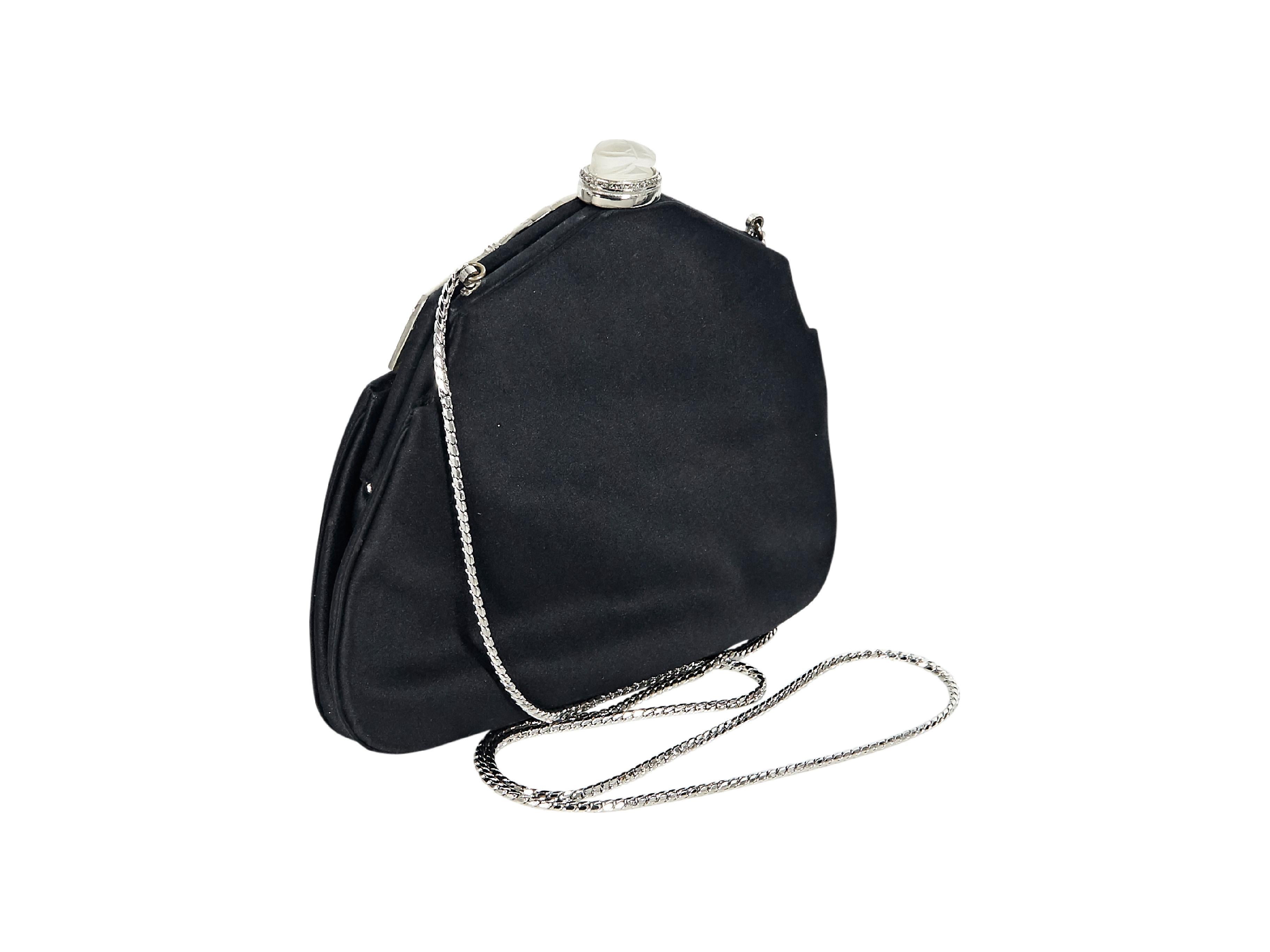 Product details:  Black satin evening bag by Judith Leiber.  Embellished with rhinestones.  Tuck-away shoulder strap.  Top push-clasp closure.  Silvertone hardware.  7