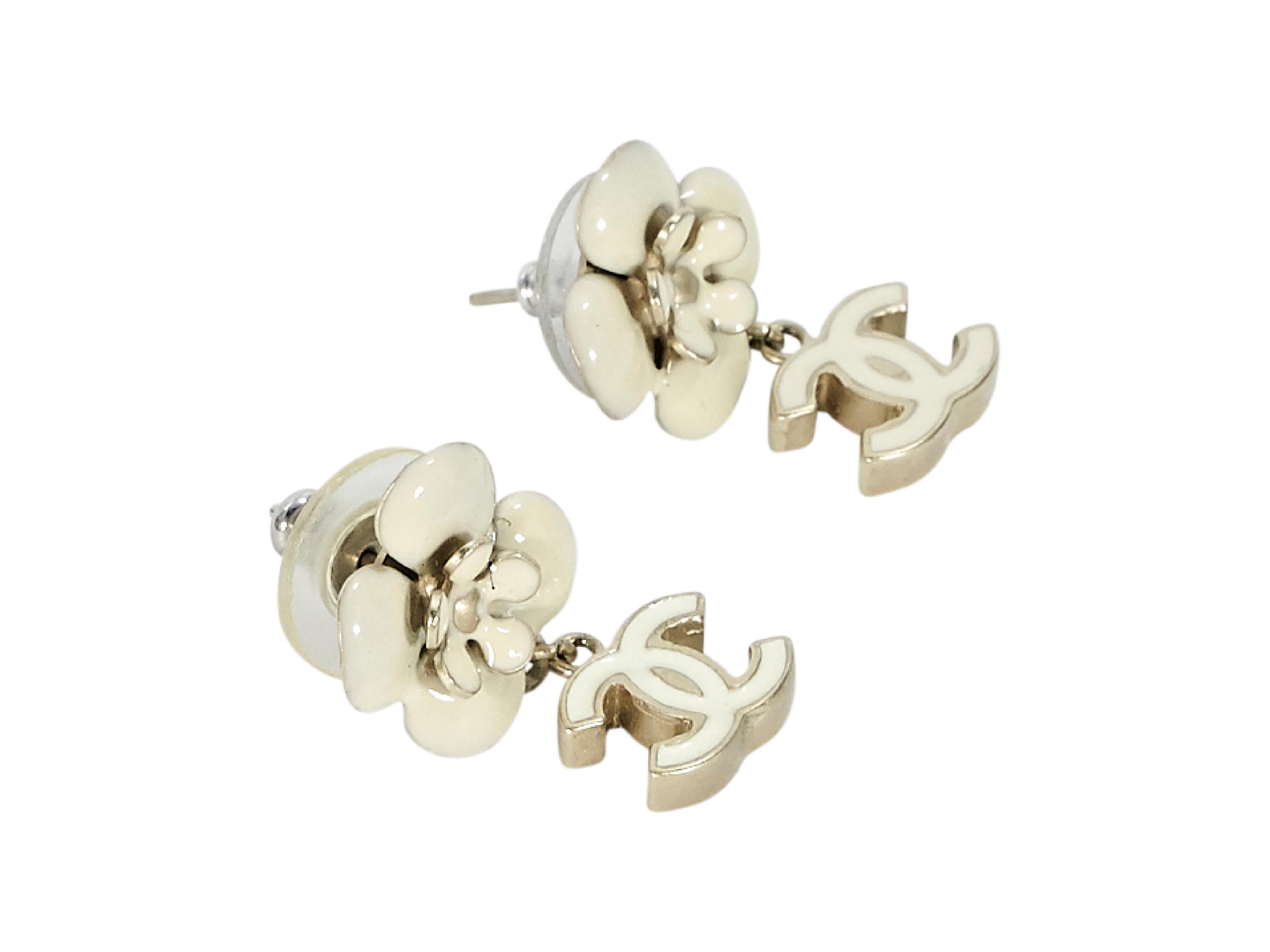 Product details:  White floral and logo drop earrings by Chanel.  Post closure.  Goldtone hardware.  0.25