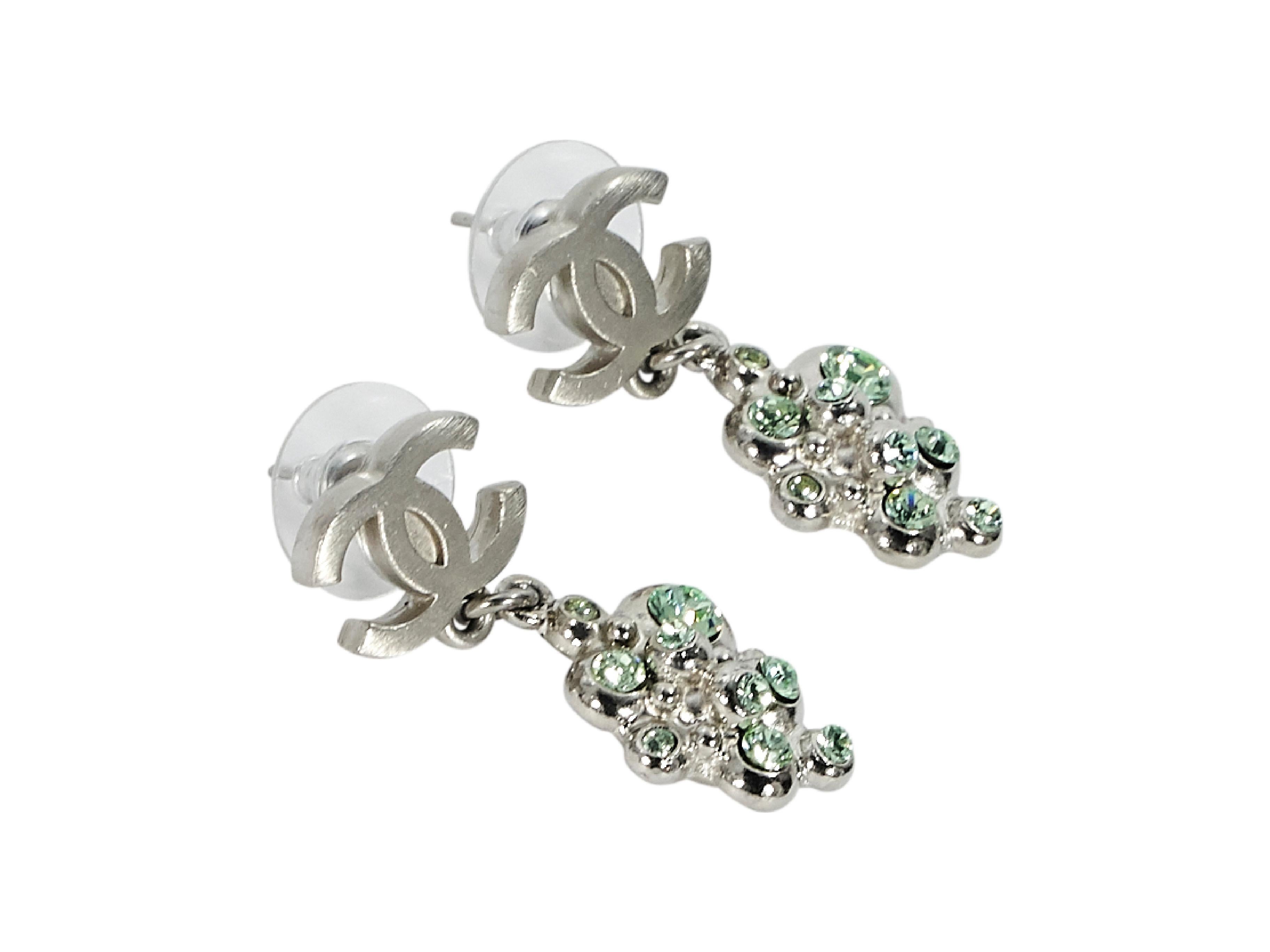 Product details:  Silvertone logo drop earrings by Chanel.  Green crystal cluster drop.  Post closure.  0.5