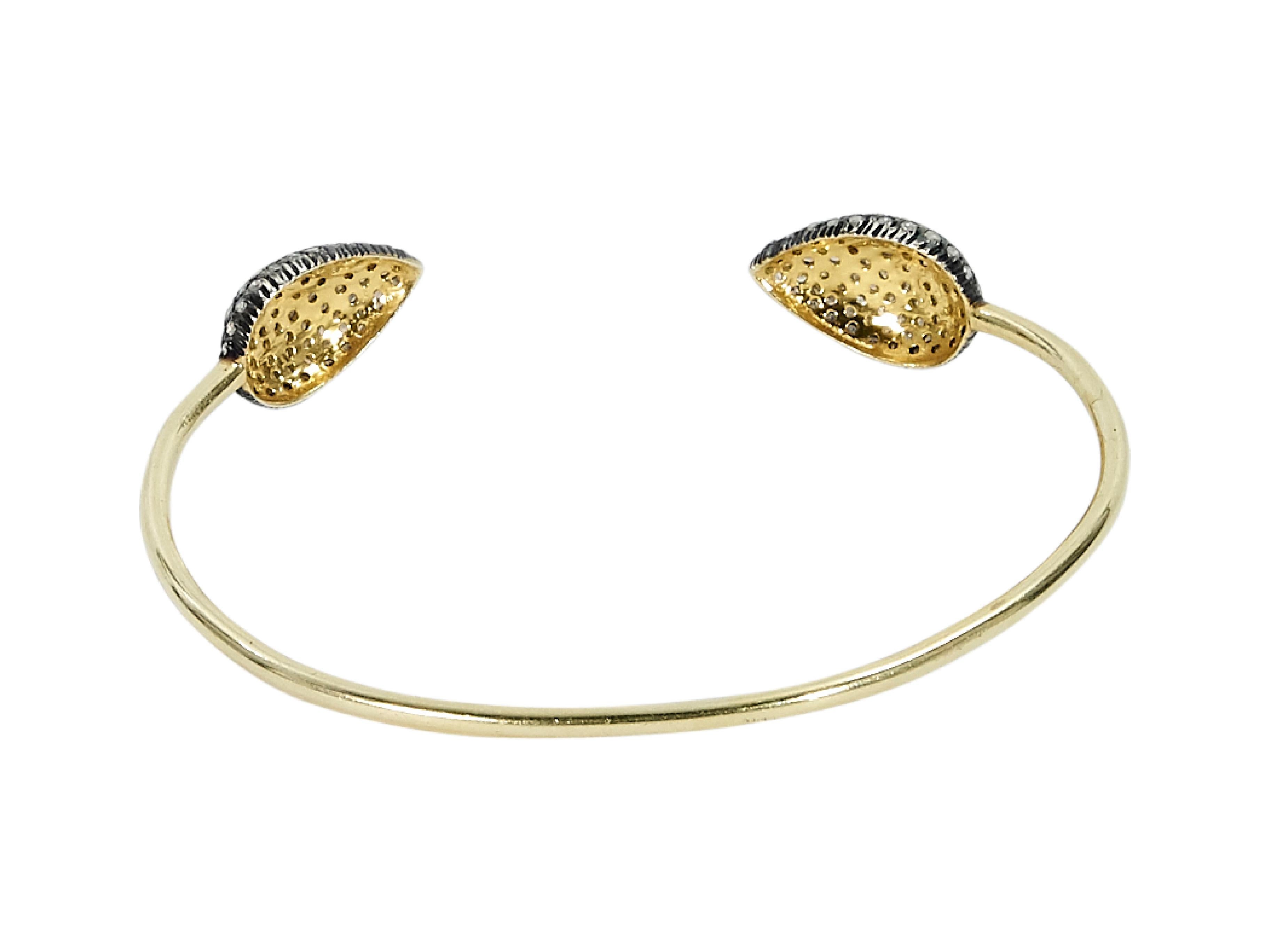 Product details:  Goldtone cuff bracelet by Jennifer Miller.  Crystal embellished ends.  8