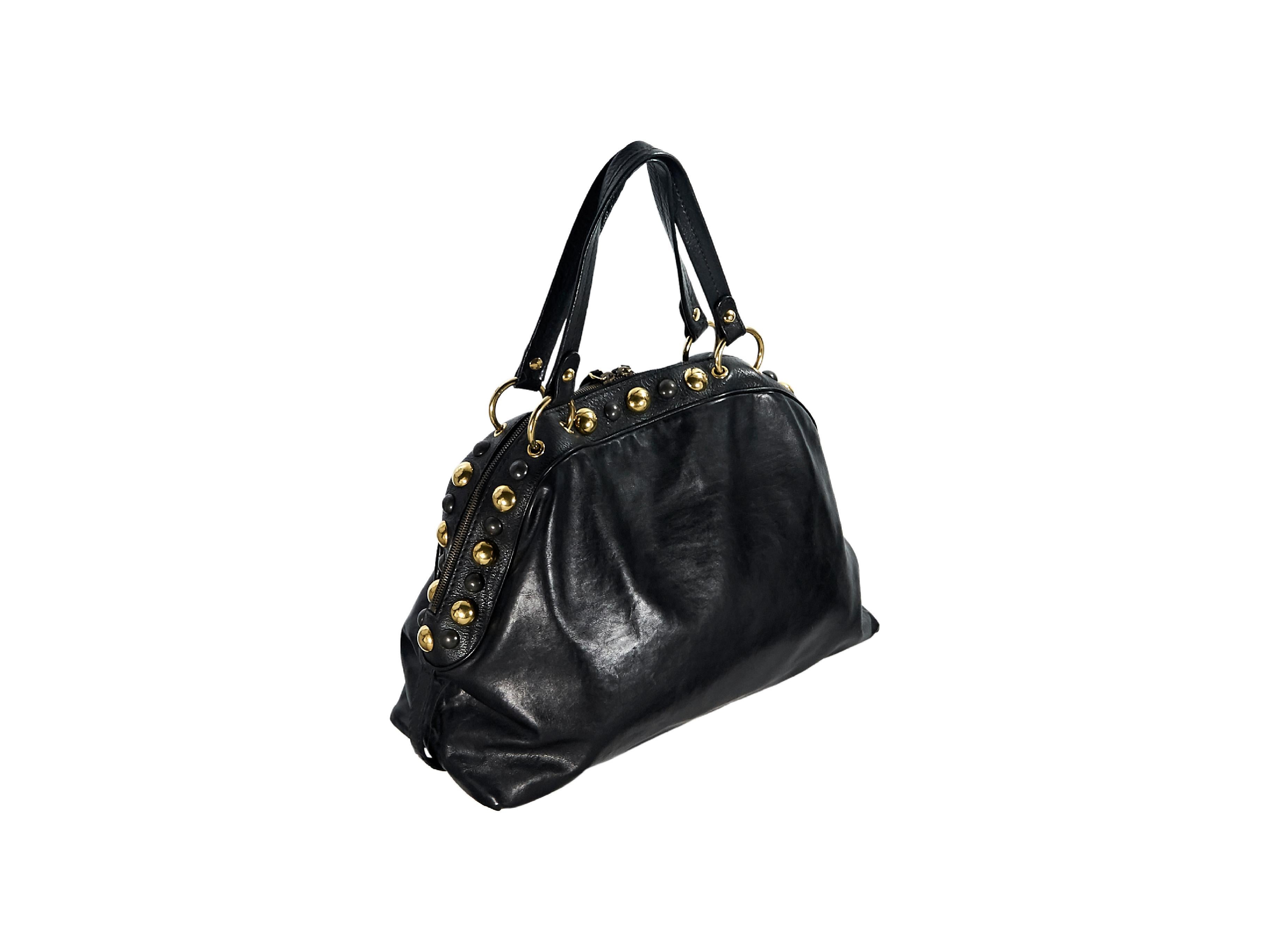 Product details:  Vintage black studded leather Babouska tote bag by Gucci.  Dual shoulder straps.  Top zip closure.  Lined interior with inner zip and slide pockets.  Protective metal feet.  Goldtone hardware.  18
