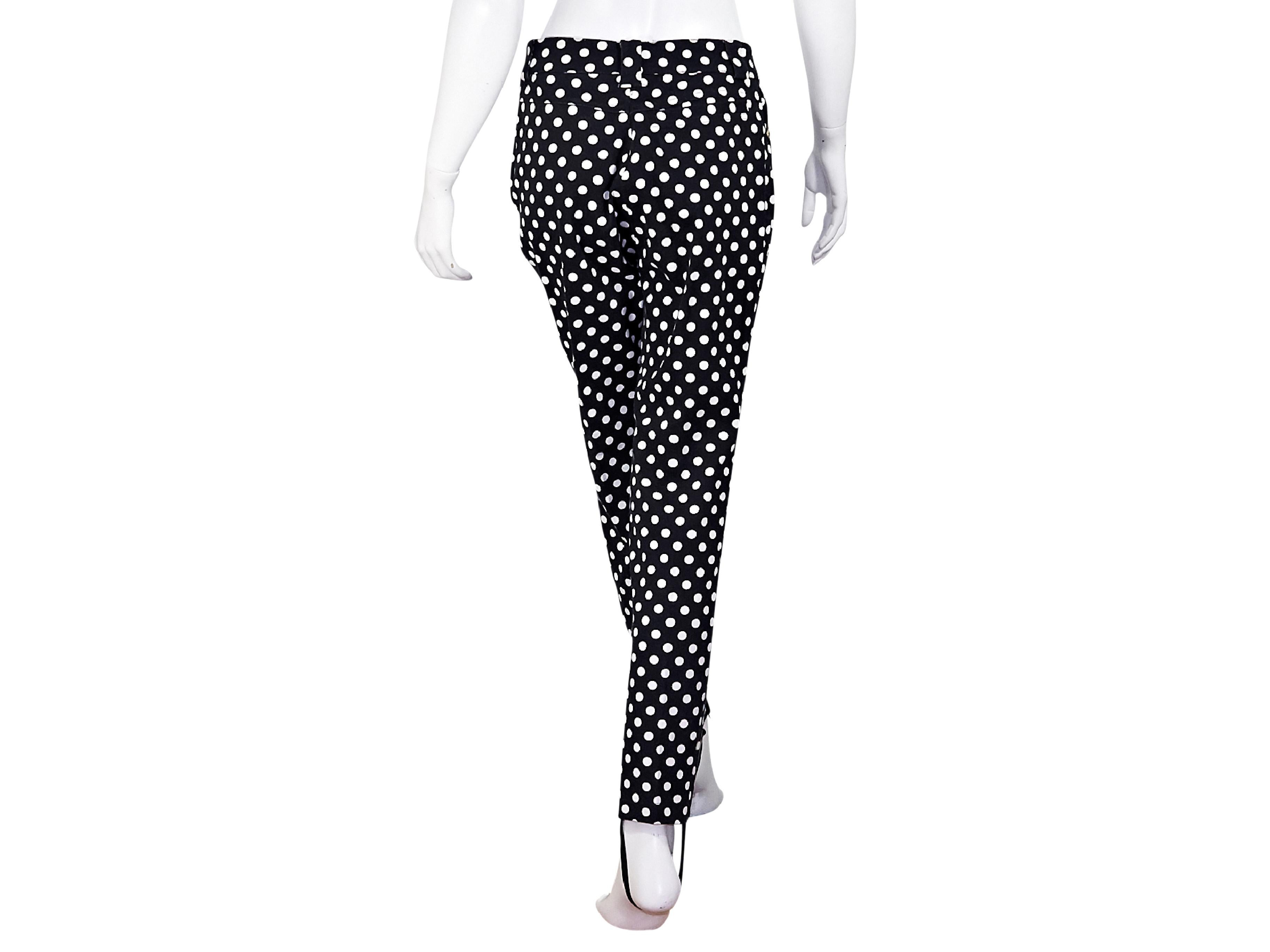 Product details:  Vintage black and white polka-dot stirrup pants by Gianni Versace Couture.  High rise.  Banded waist with belt loops.  Button and zip fly closure.  Goldtone hardware.  30