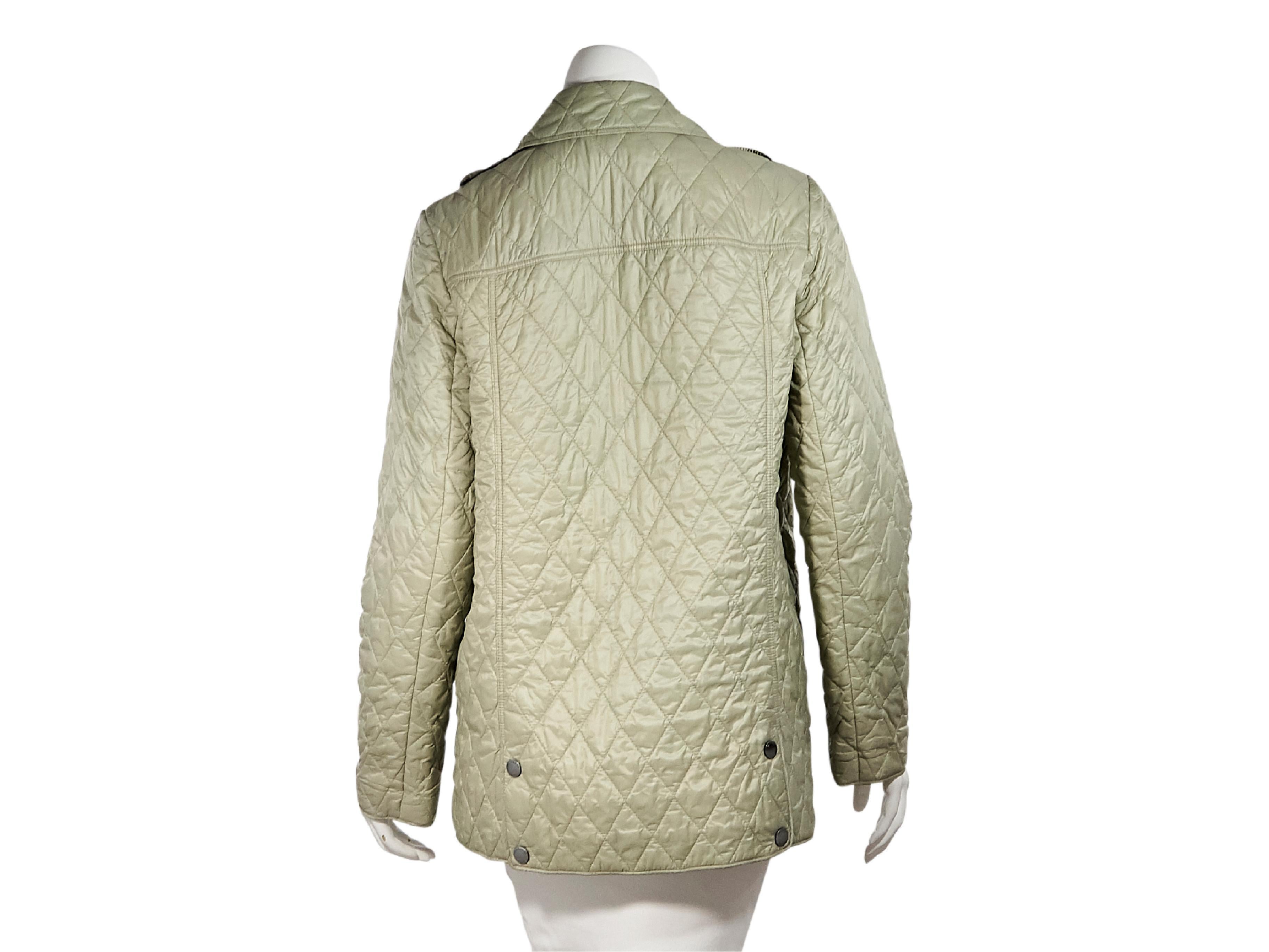 Product details:  Light green quilted jacket by Burberry.  Spread collar.  Long sleeves.  Snap-front closure.  Waist patch pockets.  Snap back hem vents.  Silvertone hardware.  38