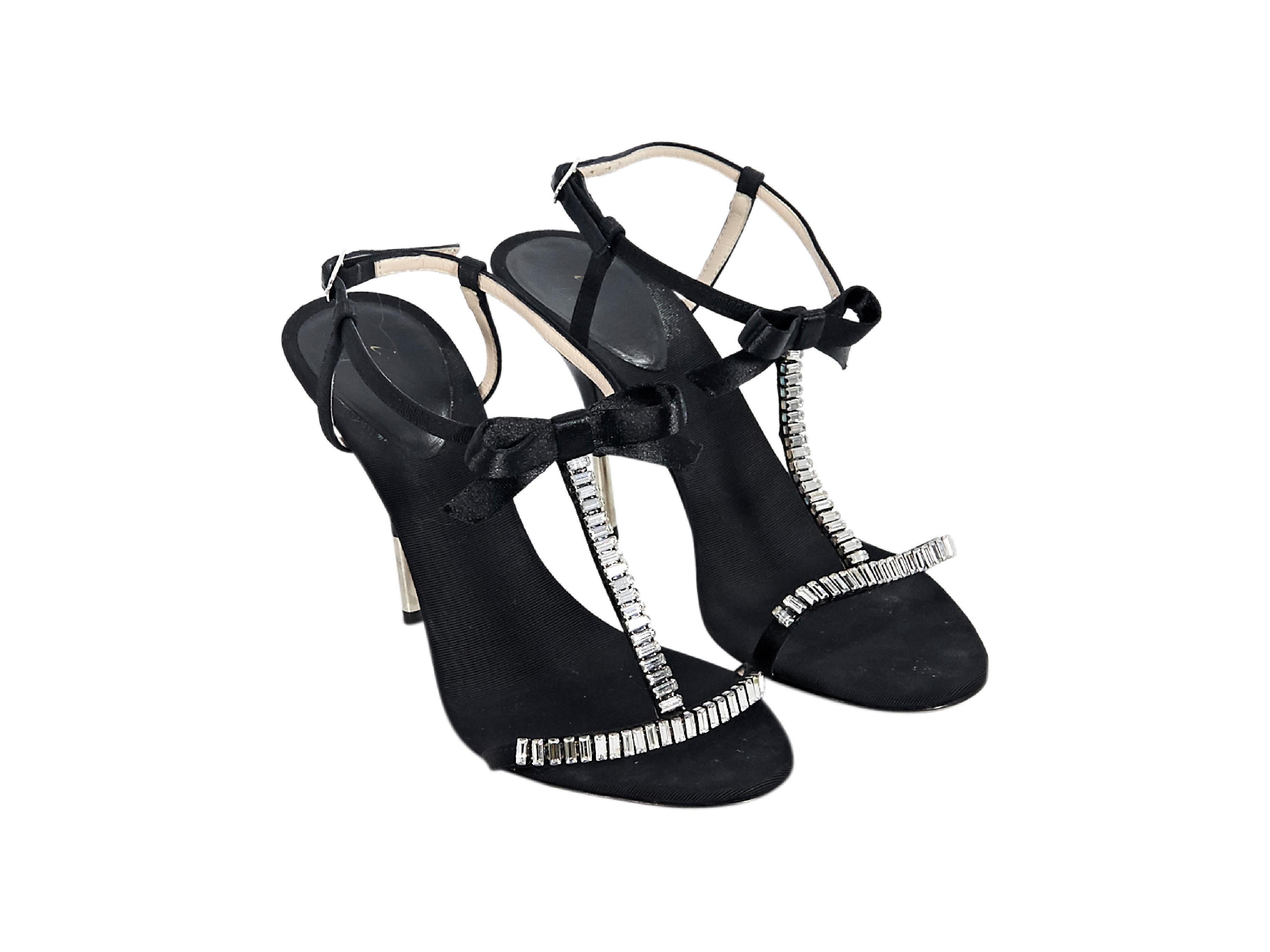 Product details:  Black slingback evening sandals by Giuseppe Zanotti.  Embellished with a bow and crystals.  Adjustable slingback strap.  Open toe.  Silvertone hardware.  Original box and dust bag included.  4