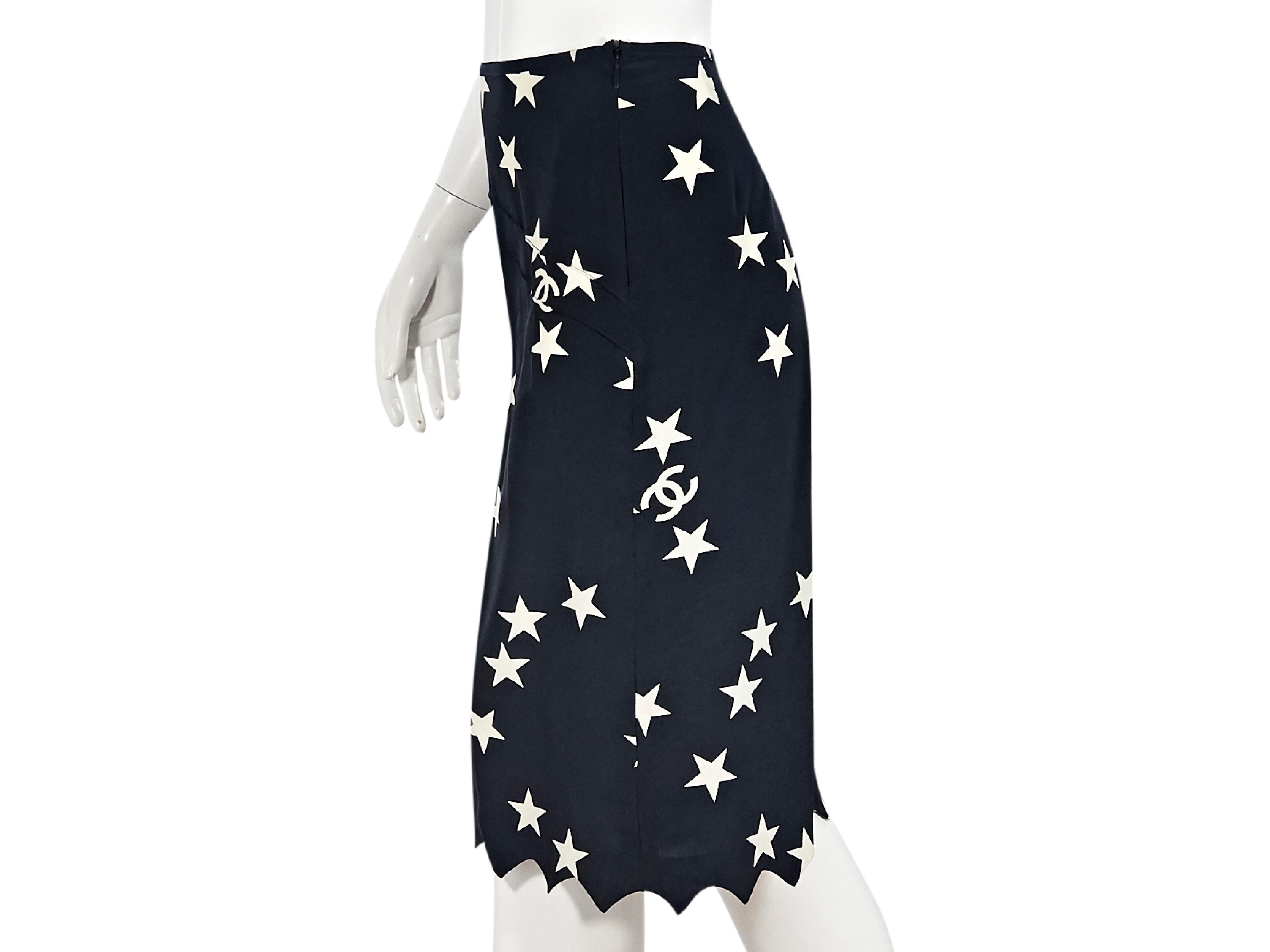 Product details:  Navy blue and white star-printed silk culottes by Chanel.  Concealed side zip closure.  Pinked hem.  Label size FR 40.  31