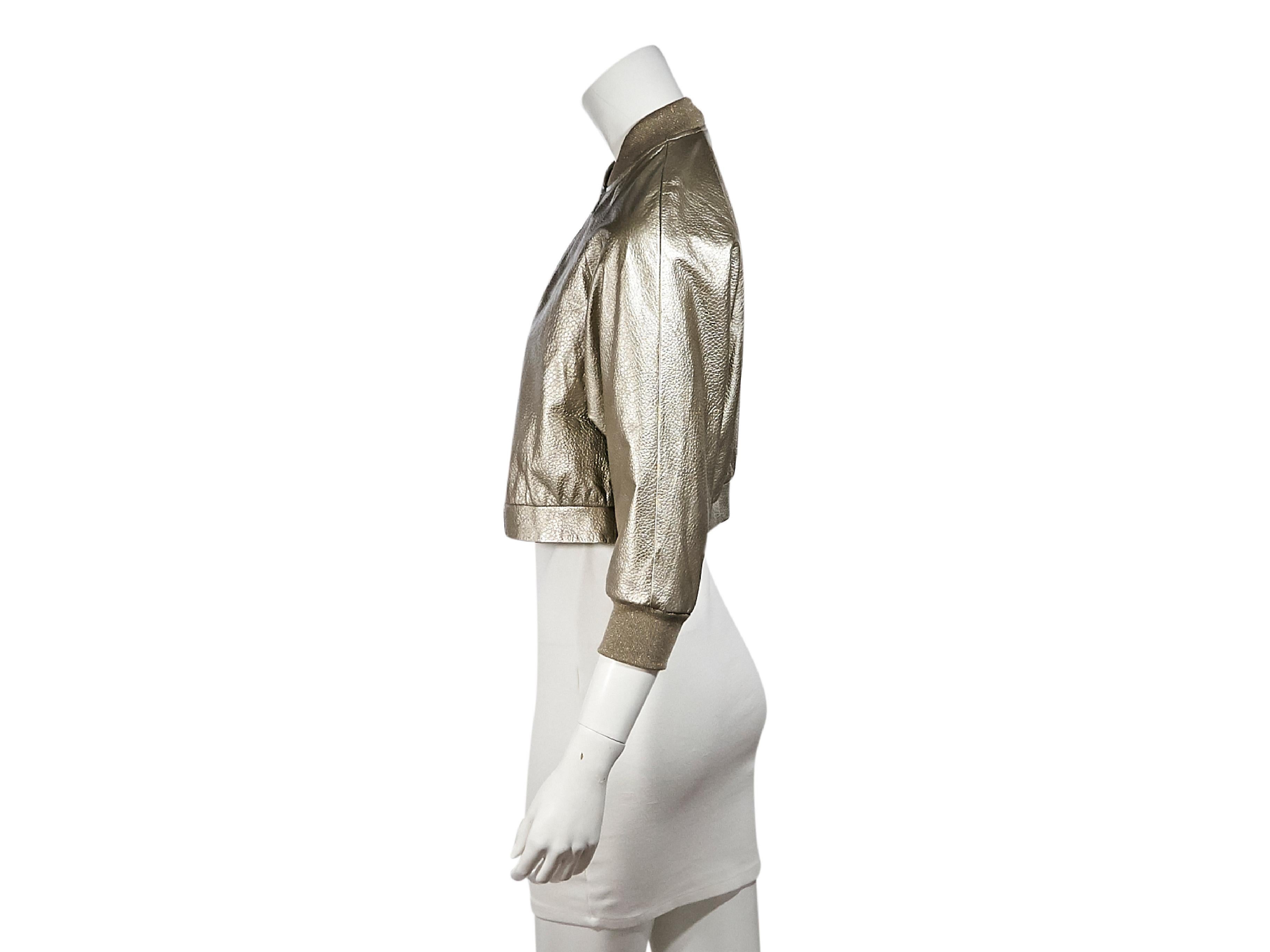 Product details:  Metallic silver leather cropped bomber jacket by Brunello Cucinelli.  Stand collar.  Three-quarter length sleeves.  Ribbed cuffs.  Zip-front closure.  29