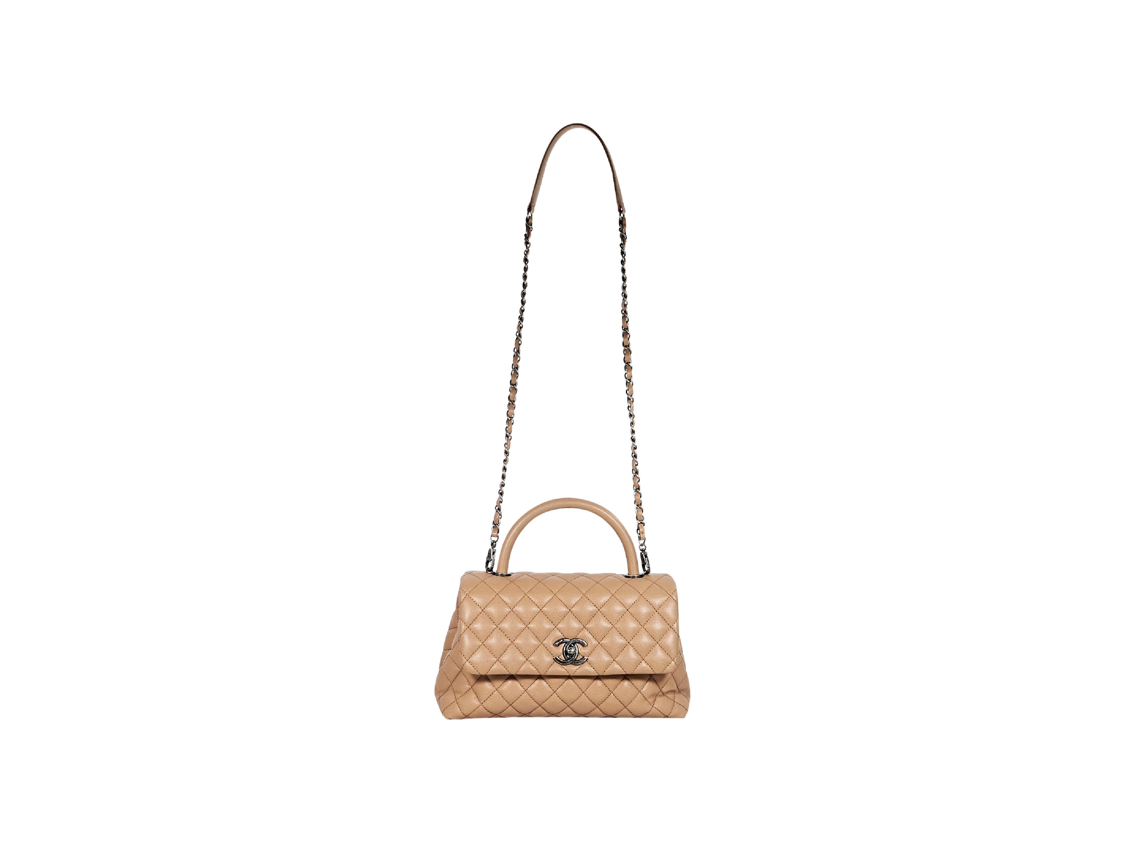 Product details:  Tan quilted caviar leather flap satchel bag by Chanel.  Top carry handle.  Detachable chain crossbody strap.  Front flap with twist-lock logo closure.  Lined interior with inner zip and slide pockets.  Back exterior slide pocket. 