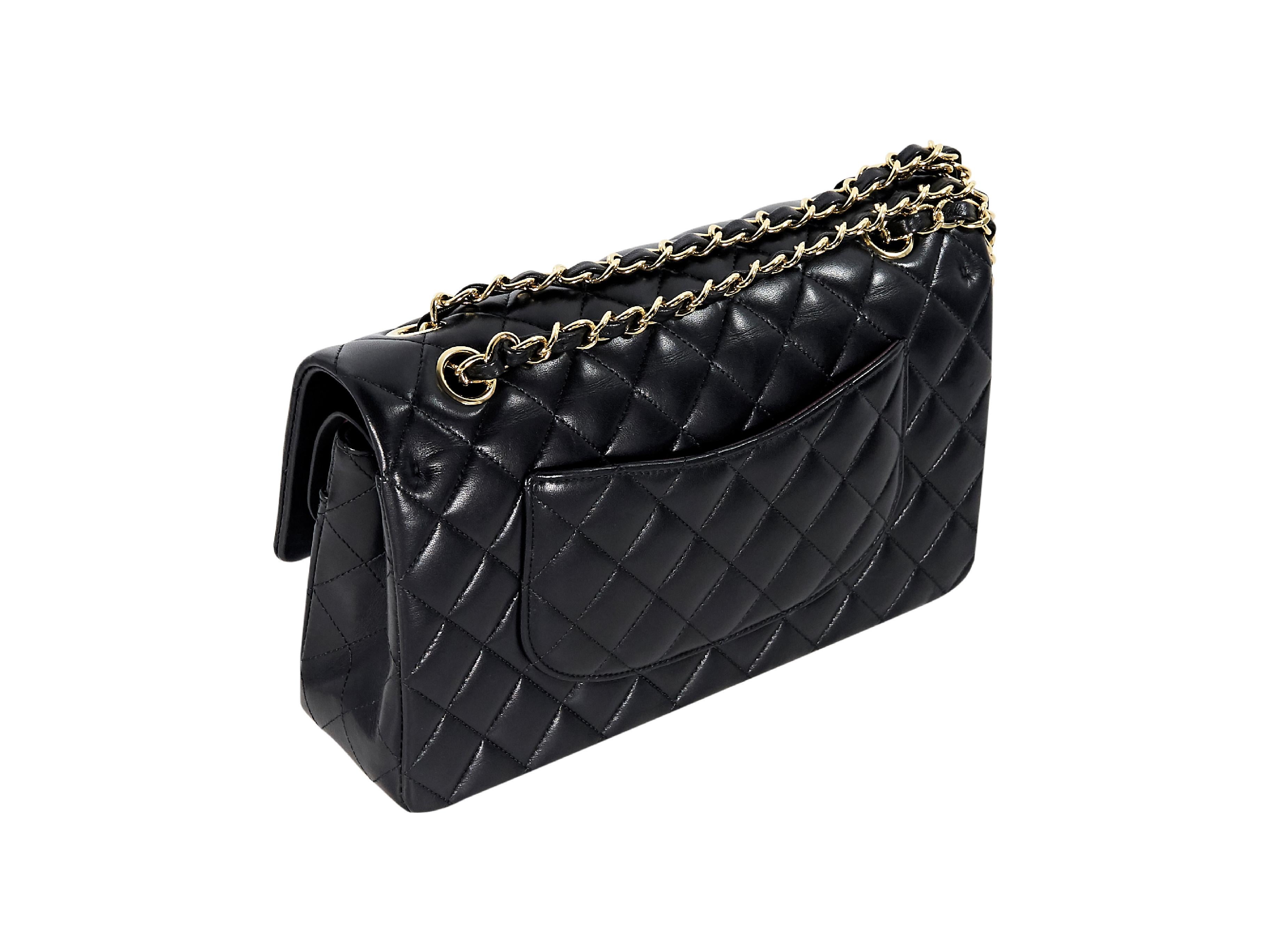 Product details:  Black quilted leather double flap shoulder bag by Chanel.  Dual chain shoulder straps.  Front flap with twist-lock closure.  Leather lined interior with inner zip and slide pockets.  Back exterior slide pocket.  Goldtone hardware. 
