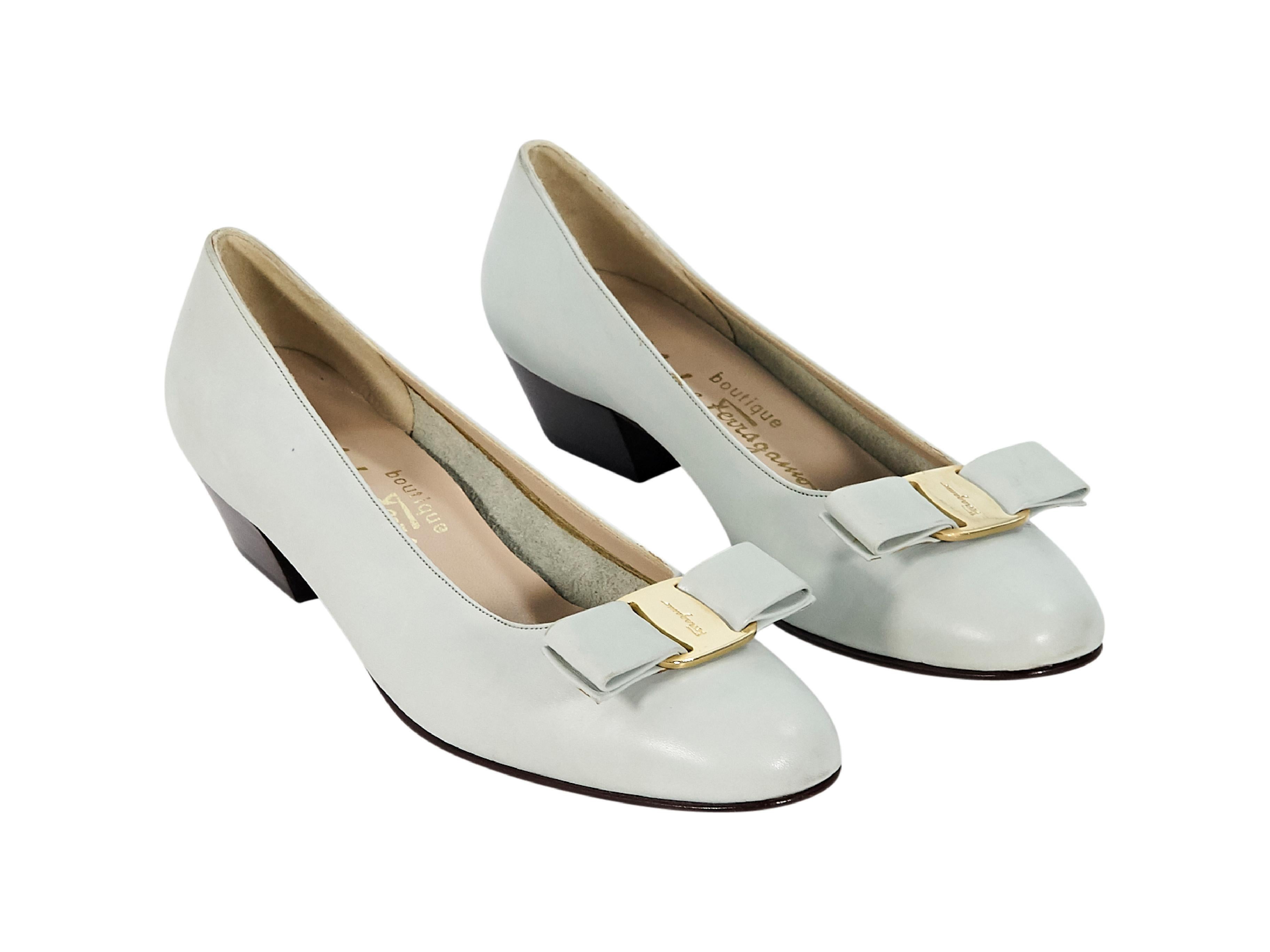 Product details:  Light grey leather ballet flats by Salvatore Ferragamo.  Bow detail at vamp.  Round toe.  Low stacked heel.  Slip-on style.  1.25