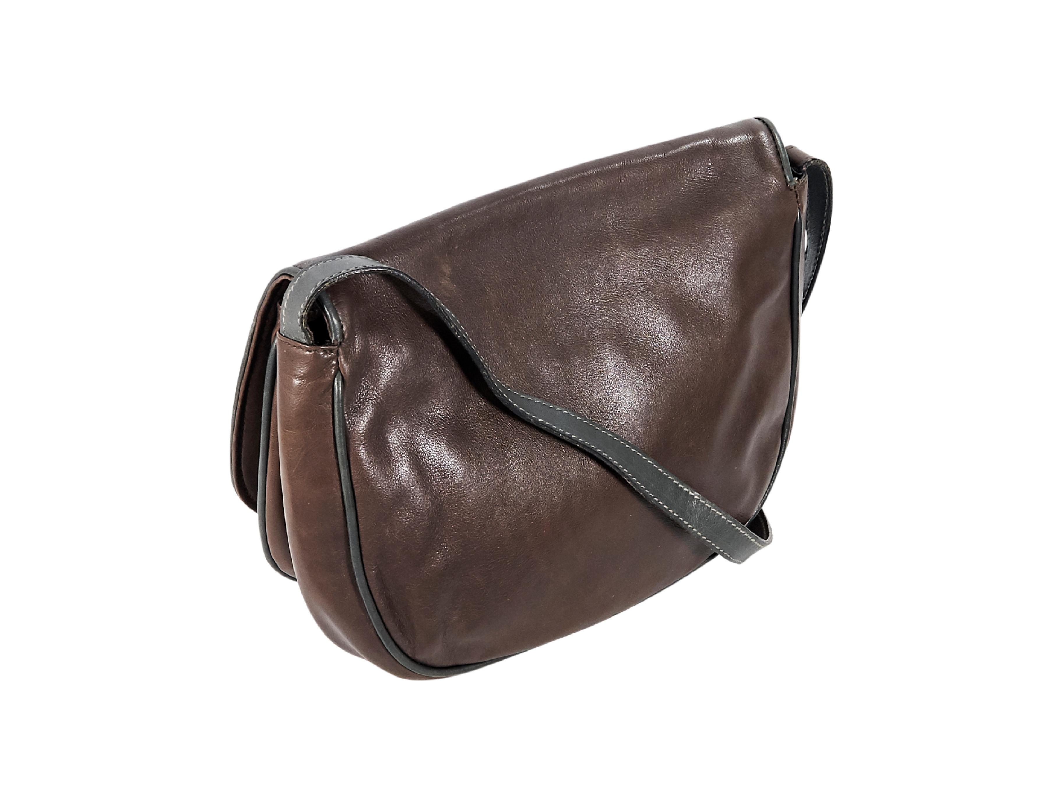 Product details:  Vintage brown leather crossbody bag by Valentino.  Two inner open compartments.  Lined interior with inner zip pocket.  Goldtone hardware.  9.5