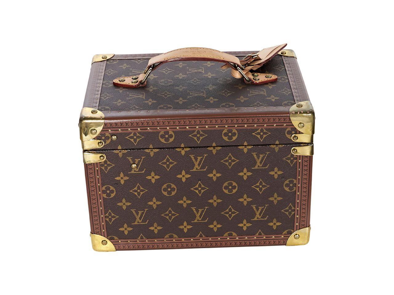 Product details:  Brown monogram coated canvas train case trunk by Louis Vuitton.  Top carry handle.  Side push-lock closure.  Lined interior with removable case.  Goldtone hardware.  8.5