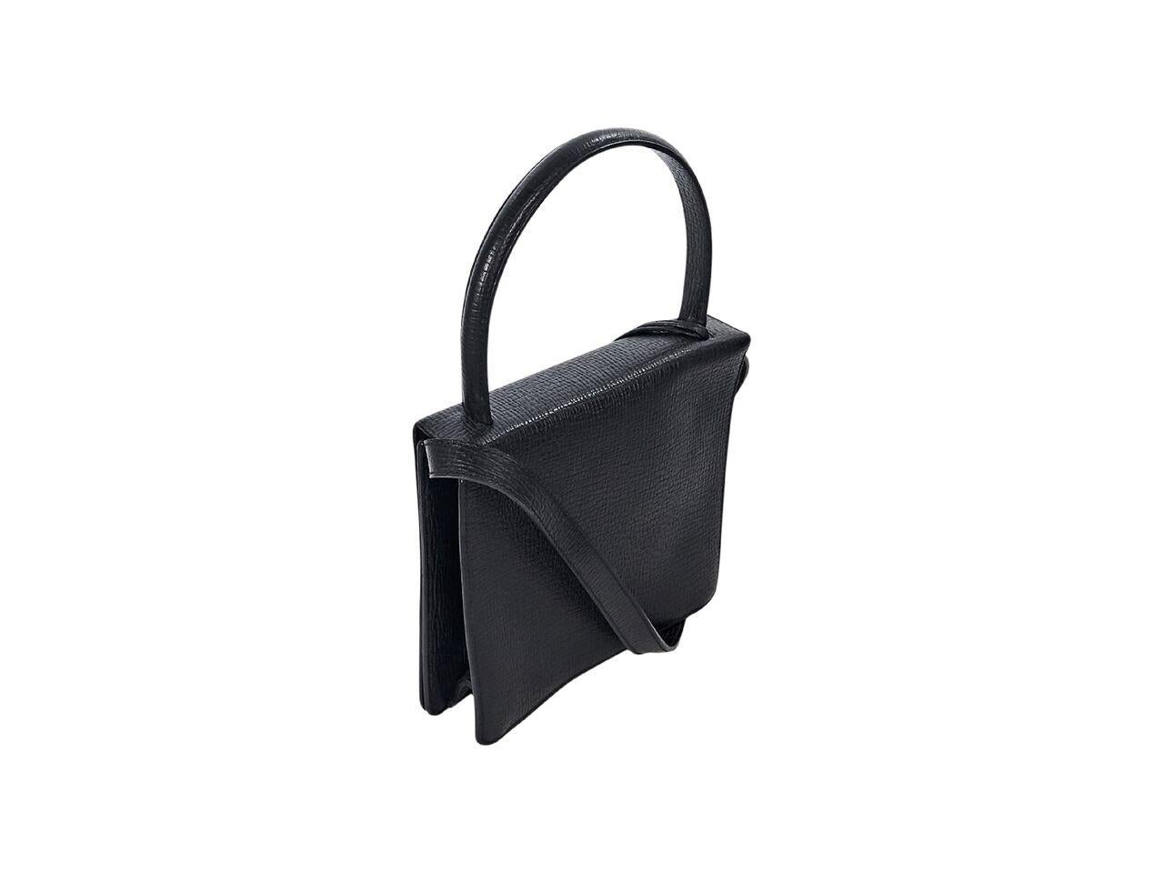 Product details:  Black textured leather crossbody bag by Loewe.  Top carry handle.  Detachable, adjustable crossbody strap.  Front flap with tab closure.  Lined interior with inner zip pocket.  Silvertone hardware.  8.75