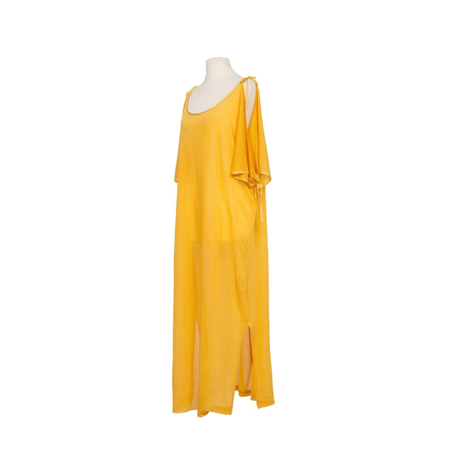 Pierre Cardin iconic mustard yellow colour dress from circa 1980's.
Straight fit, side slits, wide butterfly sleeves with adjustable bow closure in same tone yellow satin piping. 	
Original size : 40  ( It fits like Medium, 6 - 8 US, 36 - 38 EU