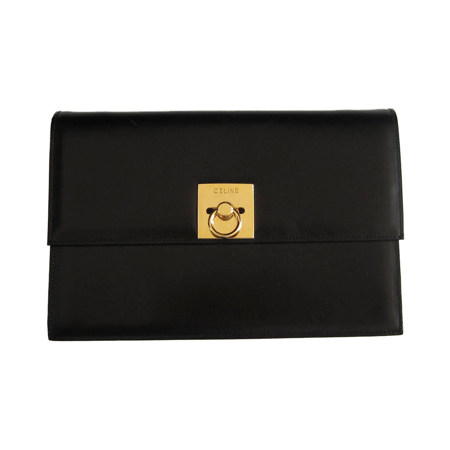 Céline Paris vintage shoulder / clutch box bag in black leather. It has a beautiful classic golden square closure with embossed logo.  
Inside - vivid orange red lining with two open pockets. Including original dust bag. 
Made in