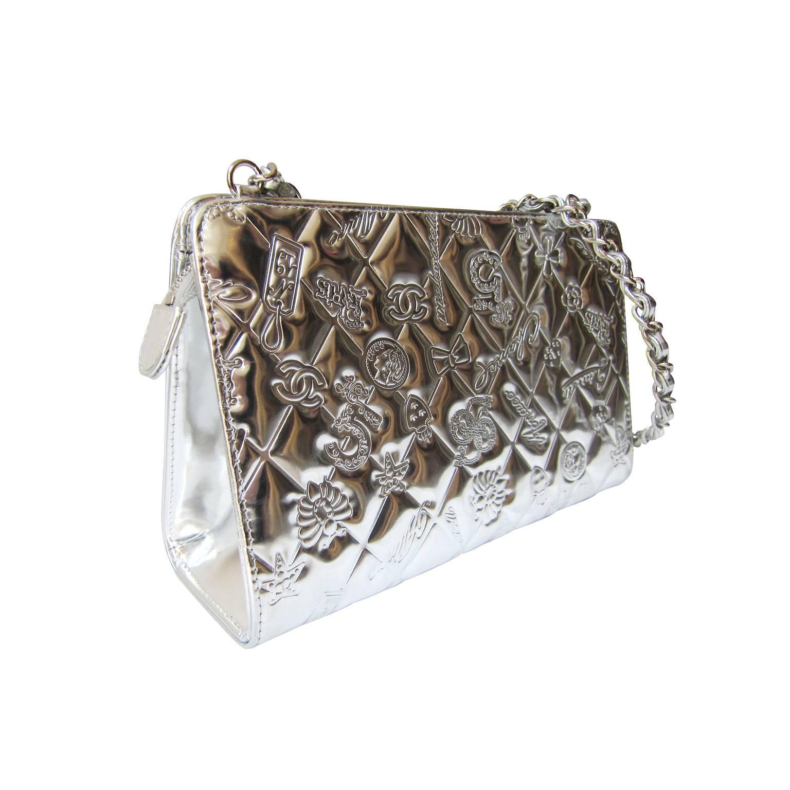 Limited edition Chanel metallic silver quilted leather embossed charm bag from 1999.
Single chain and leather entwined handle, fine textile lining with one small flat pocket interior. Zip closure. 
Made in France. 
Measurements :
14 x 23 x 7