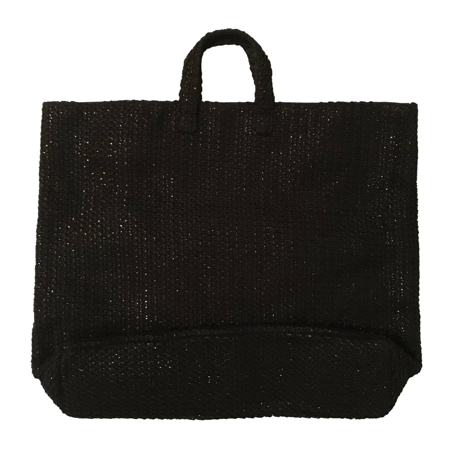 Helmut Lang tote bag from circa 90's.
Interesting texture of knitted black coated yarn has been pressed on textile.
With black lining, one inner pocket with zipper.
Measurements :
47cm x  42cm x 9 cm

