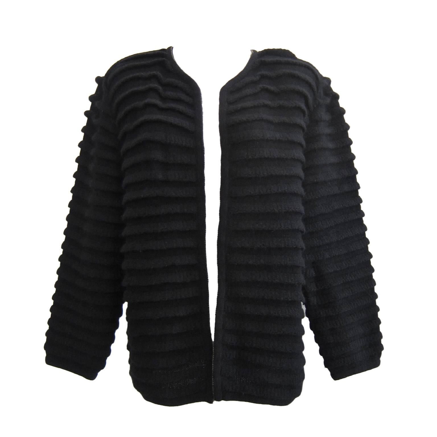 Early Issey Miyake black folded pleats knit open cardigan / jacket from 1980s. 
Each folded pleats on surface create amazing form in contrast with shadows and movement.
It fits like size Medium.
Measurements : 
Under arm 52 cm
Length 61 cm
Shoulder