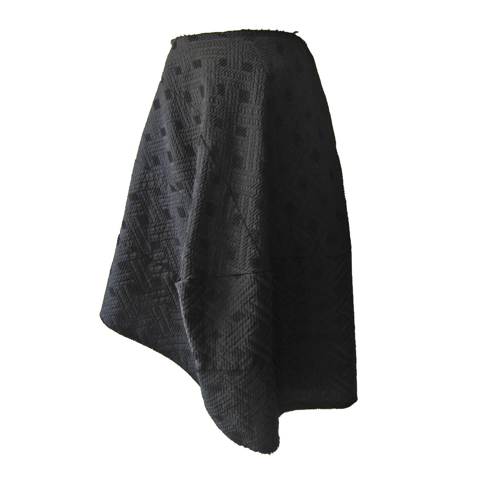 Comme des Garcons asymmetric mixed black fabric skirt from AD 2006.
Raw cut edge, Side zip closure.
Original size : S (it fits like S-M)