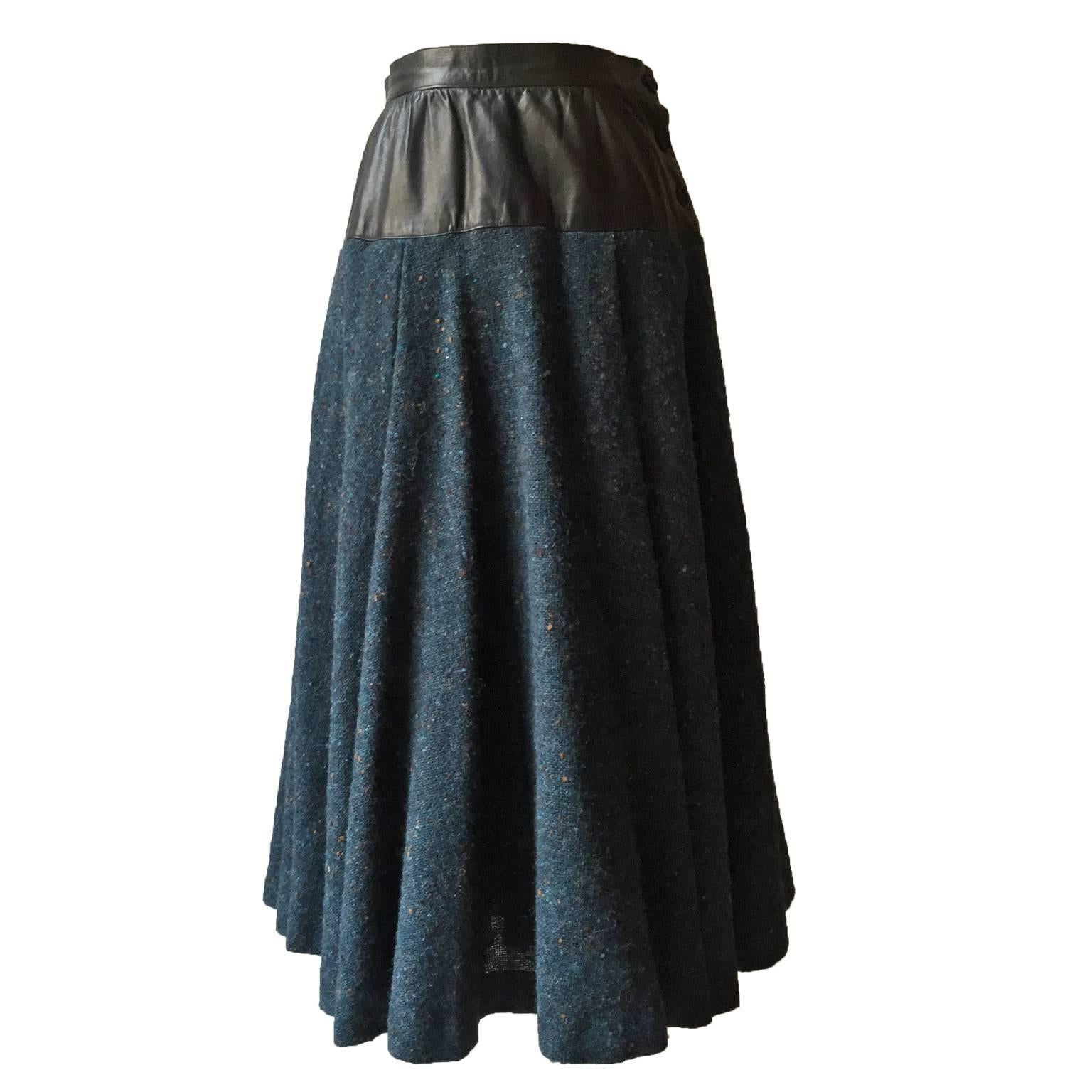 Yves Saint Laurent two toned skirt from 1980s. Dark blue base heavy tweed with leather waist detail, side button closure. 
Measurements :
Waist : 63 cm
Total length 72 cm
