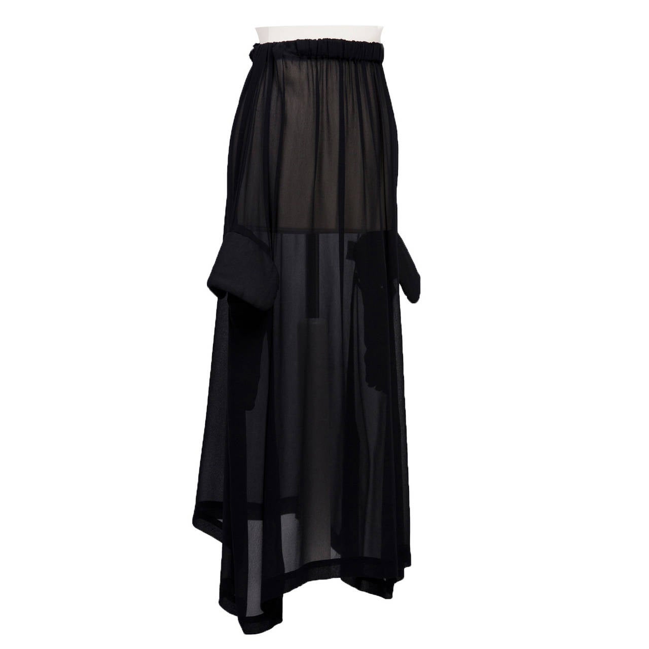 Black sheer skirt with elastic waist, padded flap pockets.