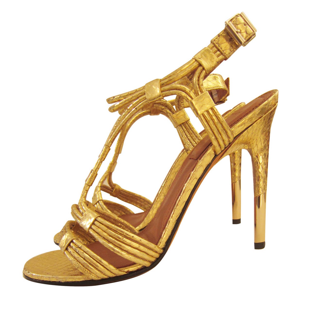 Givenchy’s metallic gold python sandals with a brand embossed insole with a high heel. Made in Italy.