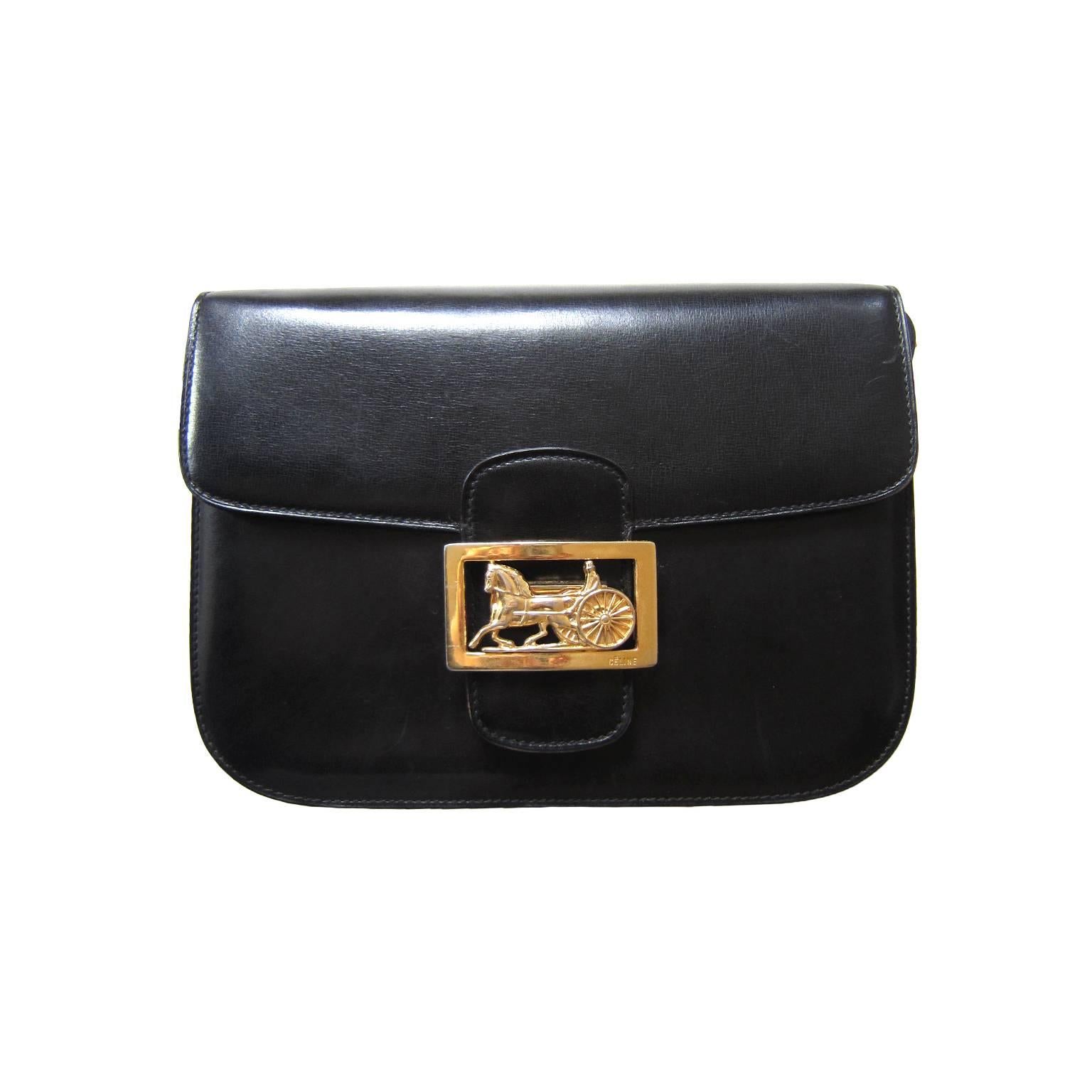 Céline vintage shoulder box bag in black leather from 70s. It has a beautifully crafted classic golden horse carriage closure. 
Inside - divided in three compartments - the back compartment features a zipper side pocket and the middle compartment
