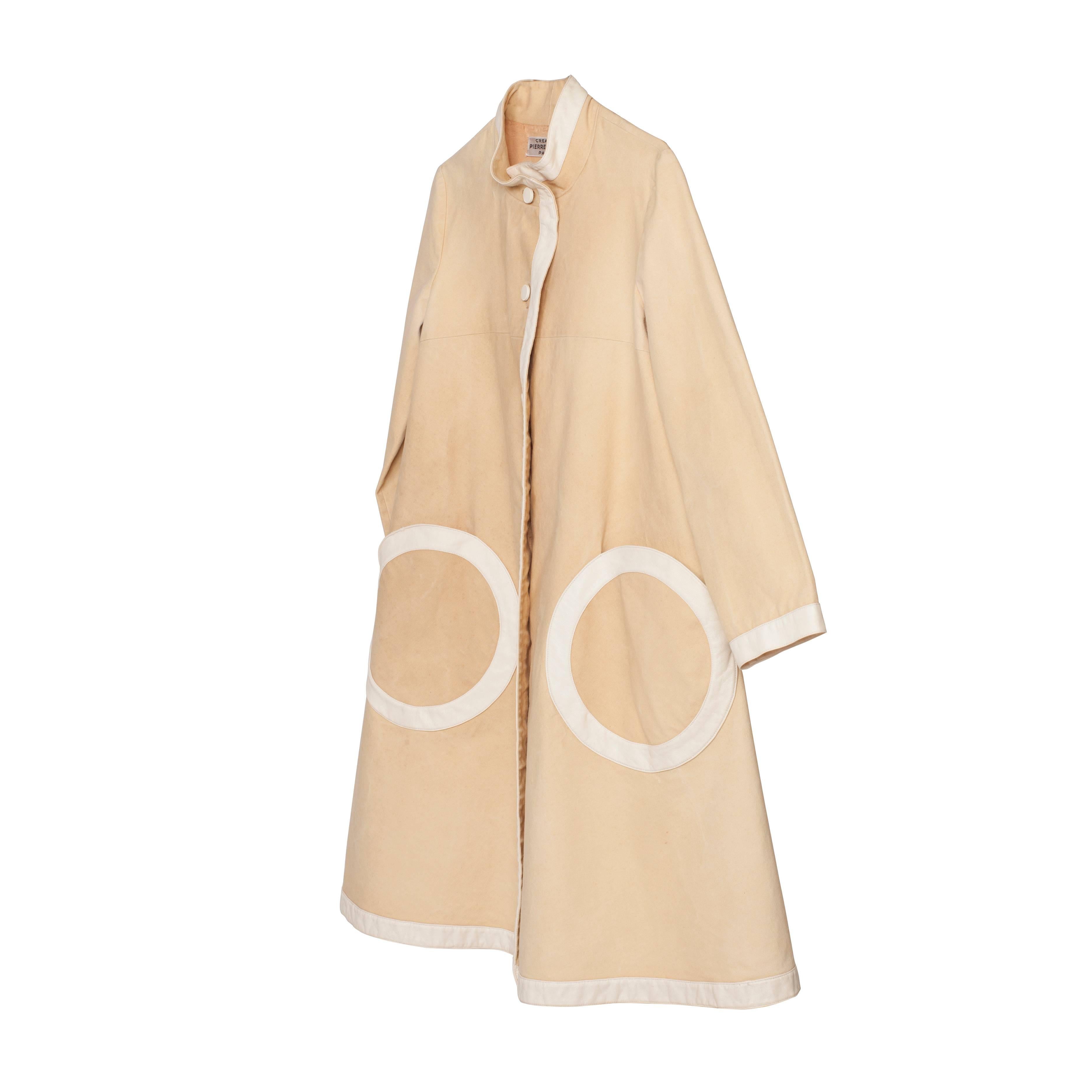 Pierre Cardin Iconic A-line swing coat from 1960s. 
Light beige cotton canvas with white leather piping hem and cuffs, large circle patch pockets in the same leather.
It fits like US 4-6, EU 6
Measurements :
Shoulder : 39 cm
Under arm : 91